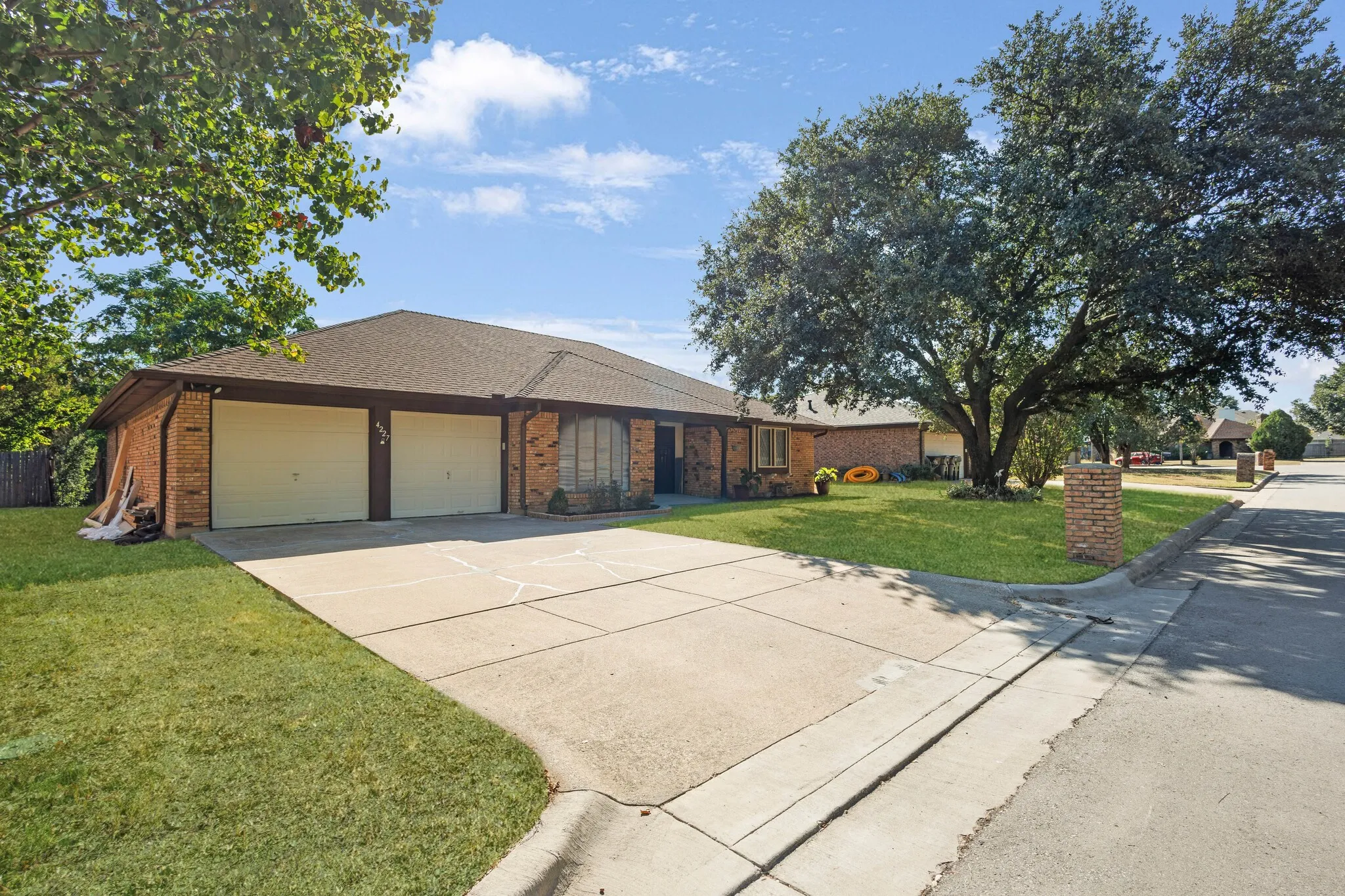 Brick exterior with a brown shingle roof