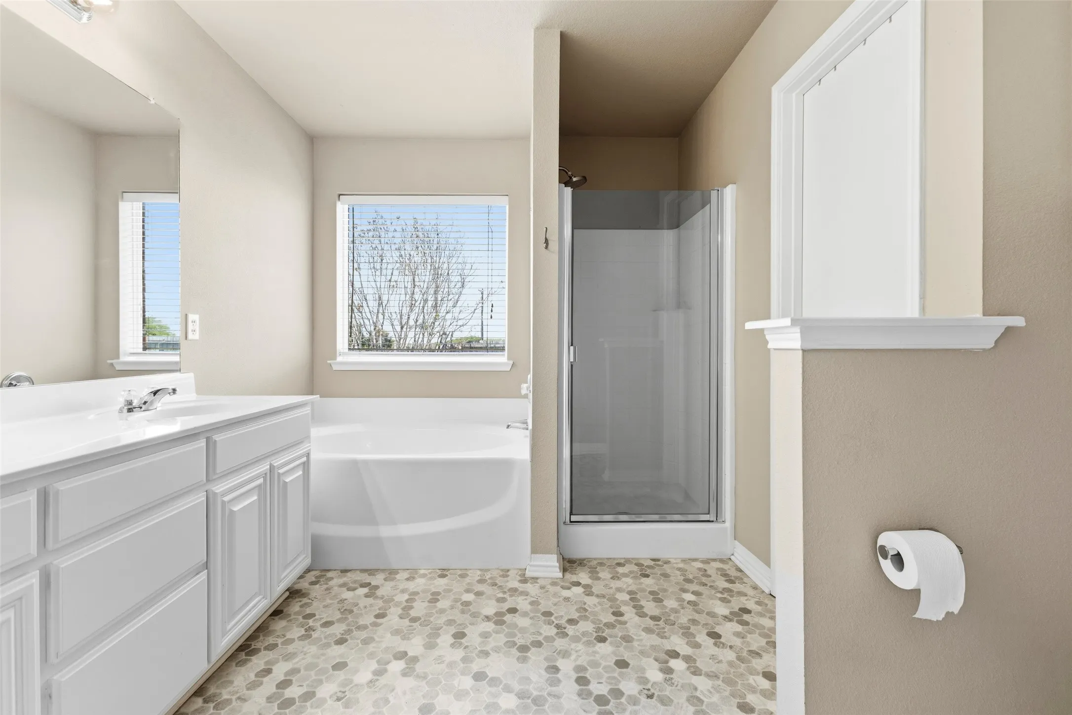 The primary bathroom has double sinks and separate tub and shower
