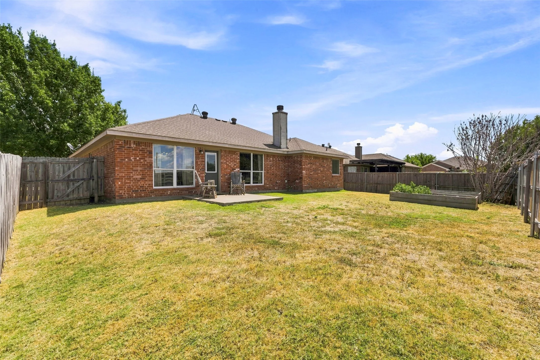Huge backyard with patio and garden boxes