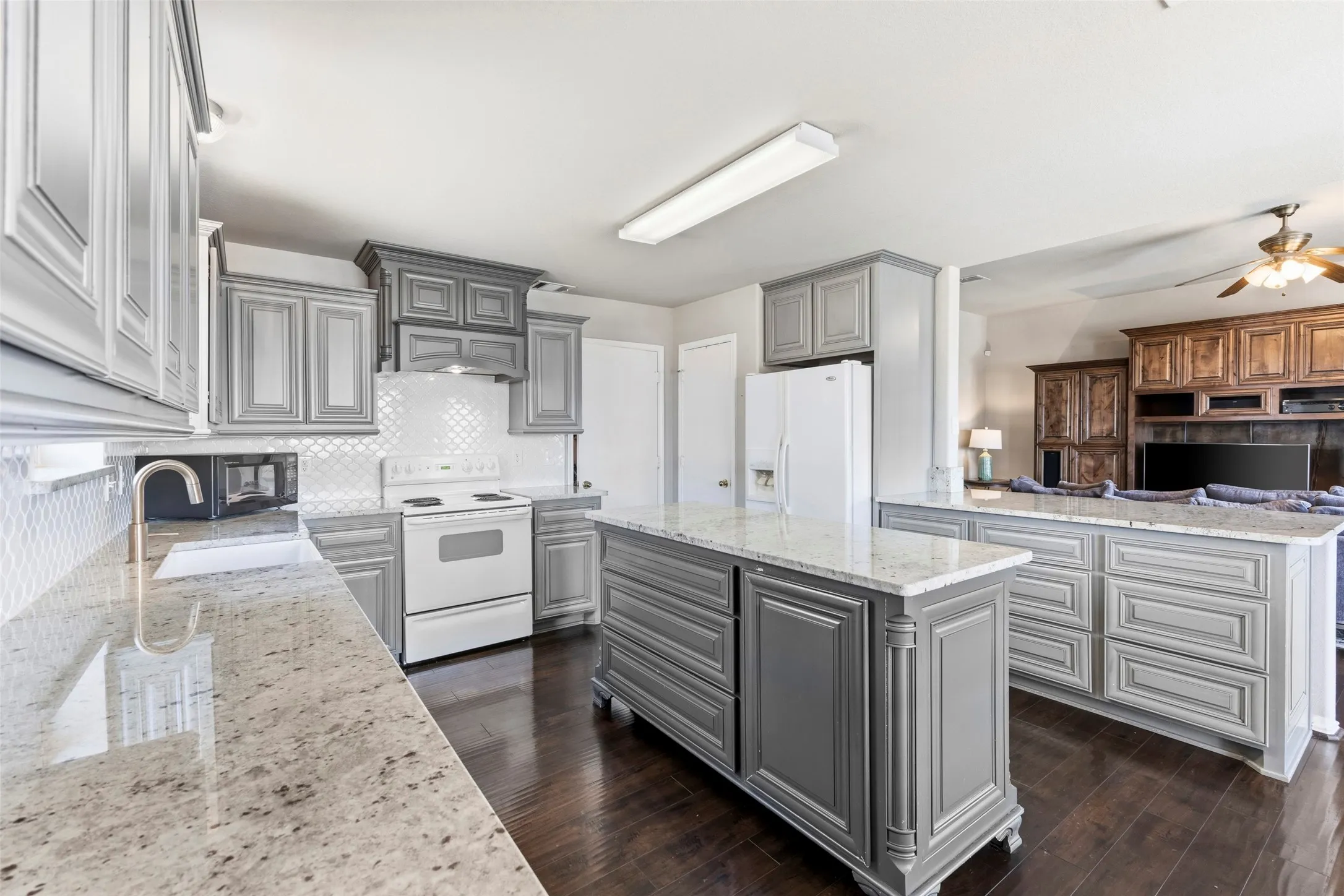 Amazing kitchen with custom cabinets, center island, and breakfast bar