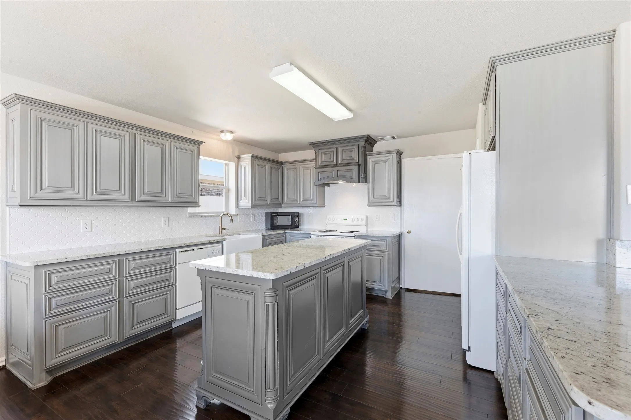 Amazing kitchen with custom cabinets, center island, and breakfast bar