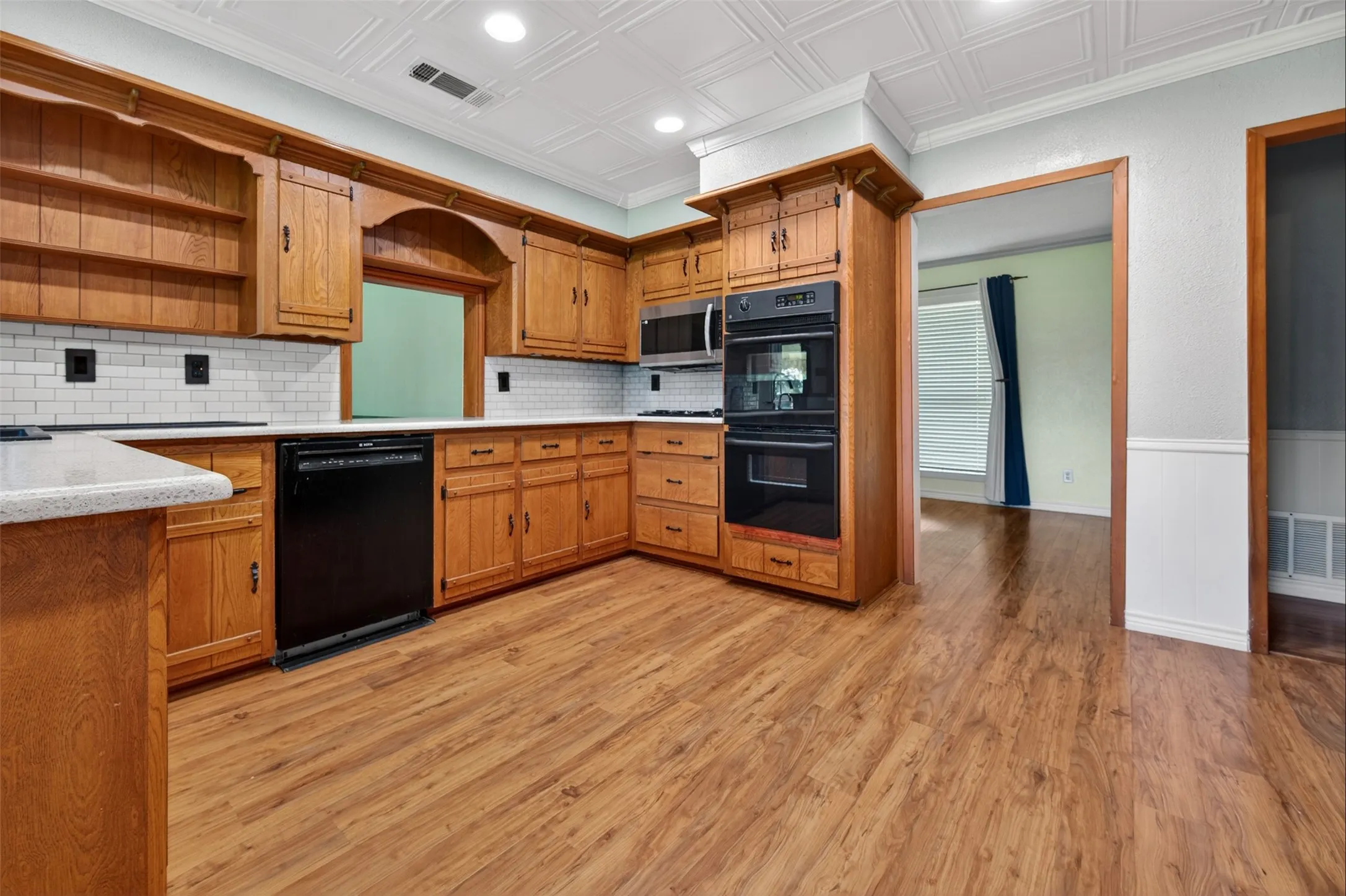 The kitchen is at the heart of the home and has lots of counter space and tons of cabinets plus newer appliances and double ovens