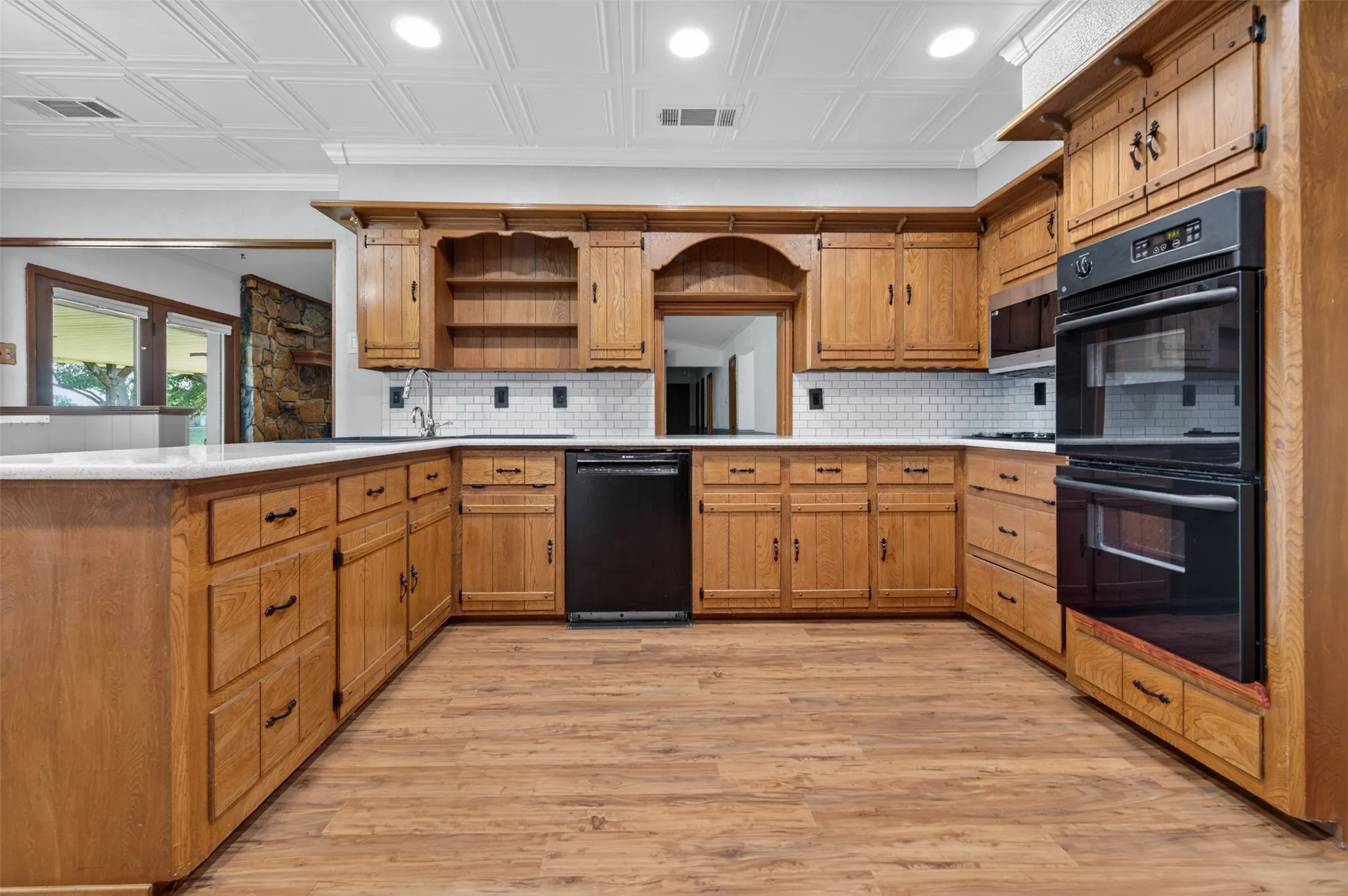The kitchen is at the heart of the home and has lots of counter space and tons of cabinets plus newer appliances and double ovens