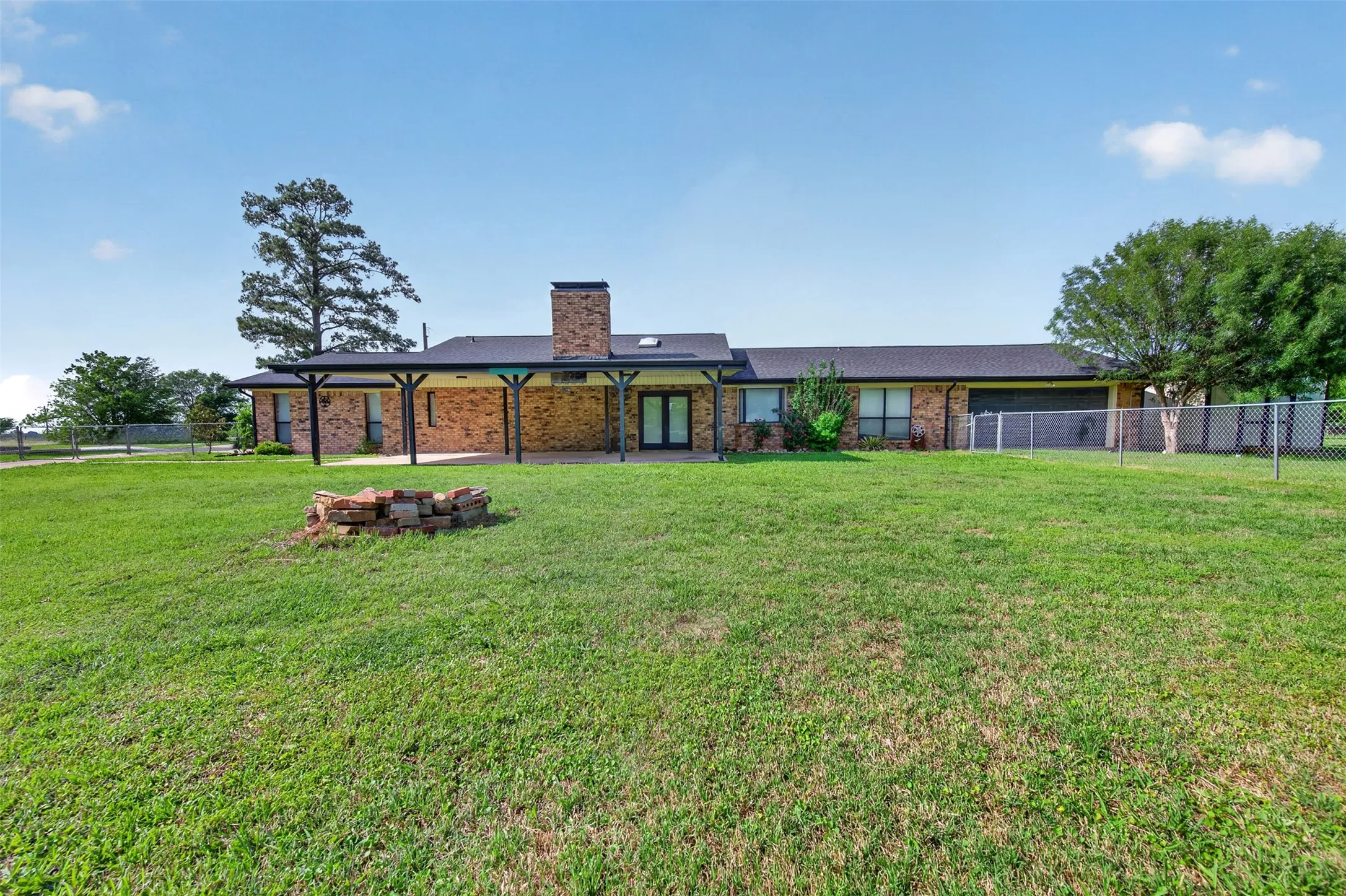 Massive backyard with covered patio and fire pit
