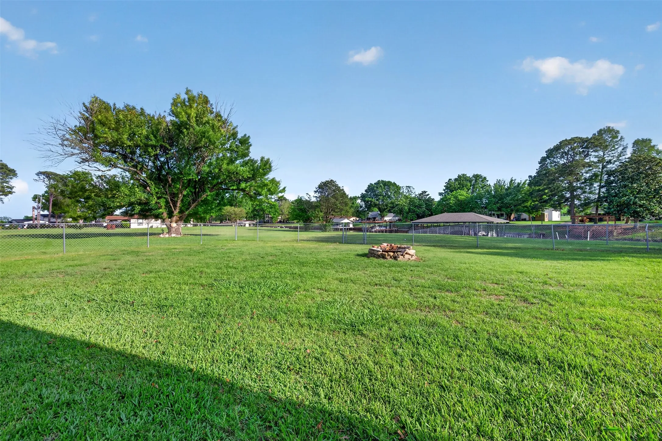Massive backyard with covered patio and fire pit