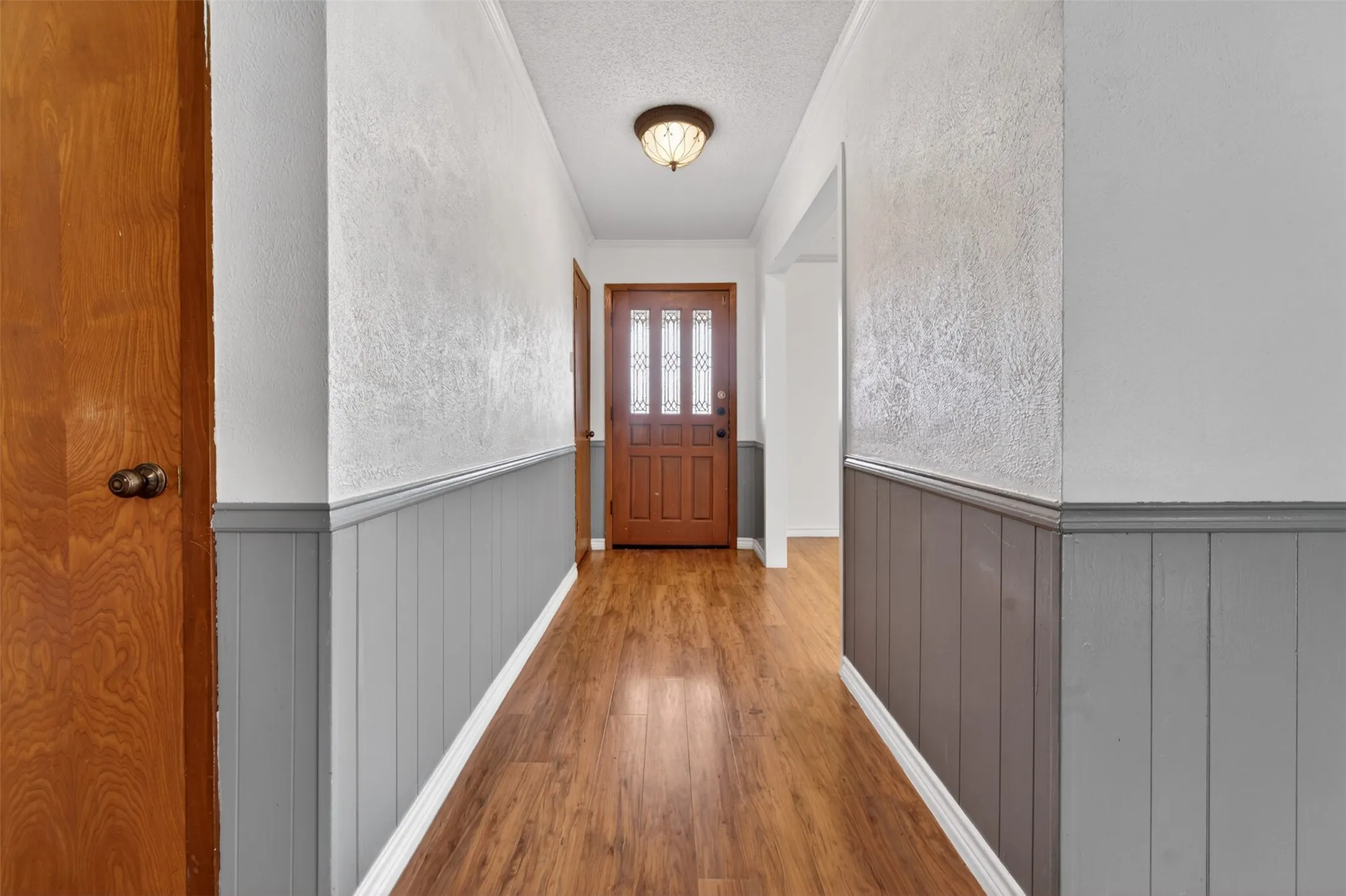 View from the living room to the front door. The formal living/dining entrance can be seen on the right of the picture