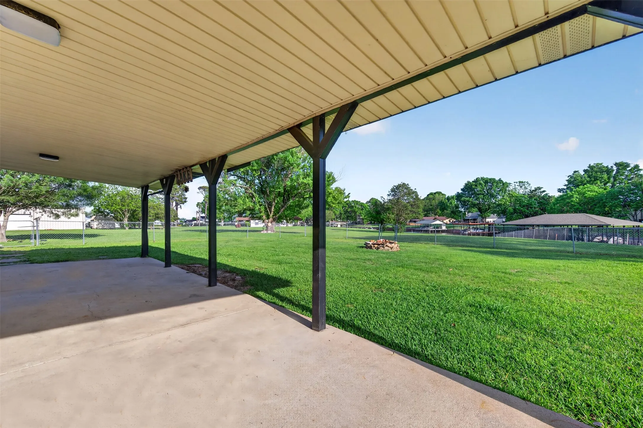 Huge covered patio looks out to the back yard