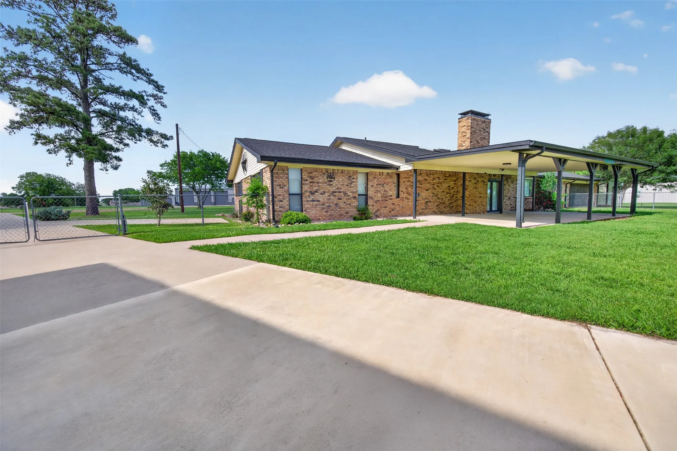 Huge covered patio looks out to the back yard plus more parking behind the gate.