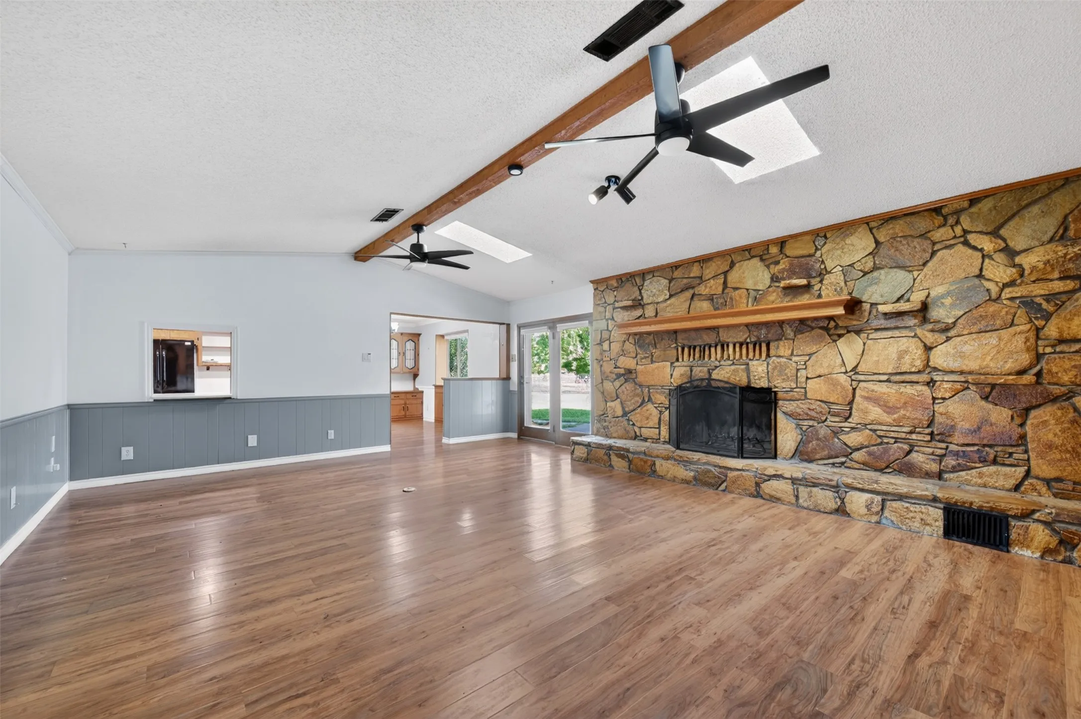 Living room with massive stone wood-burning fireplace and lots of built-ins