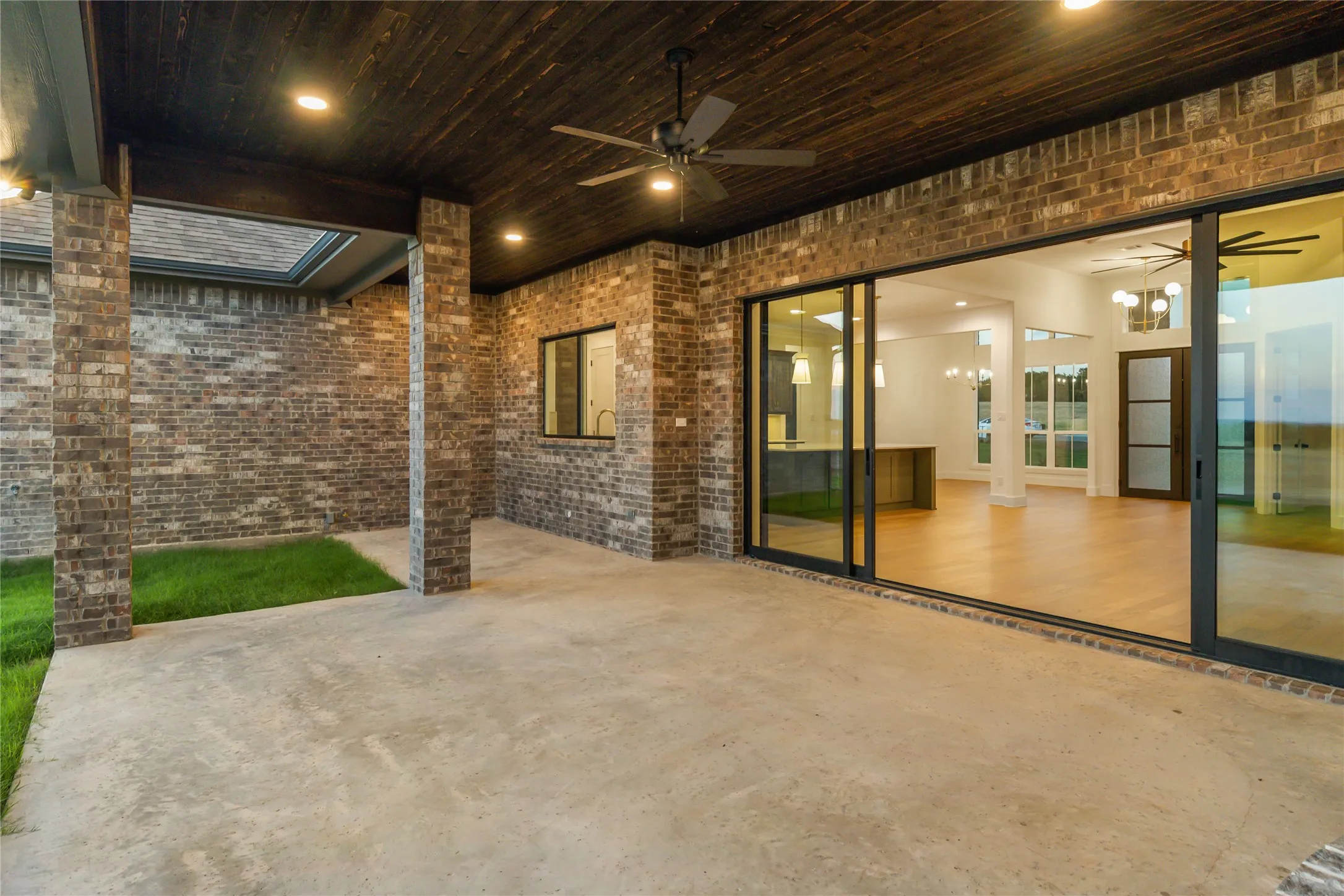 Covered patio featuring a wood-finish ceiling, recessed lighting, ceiling fan, and brick columns