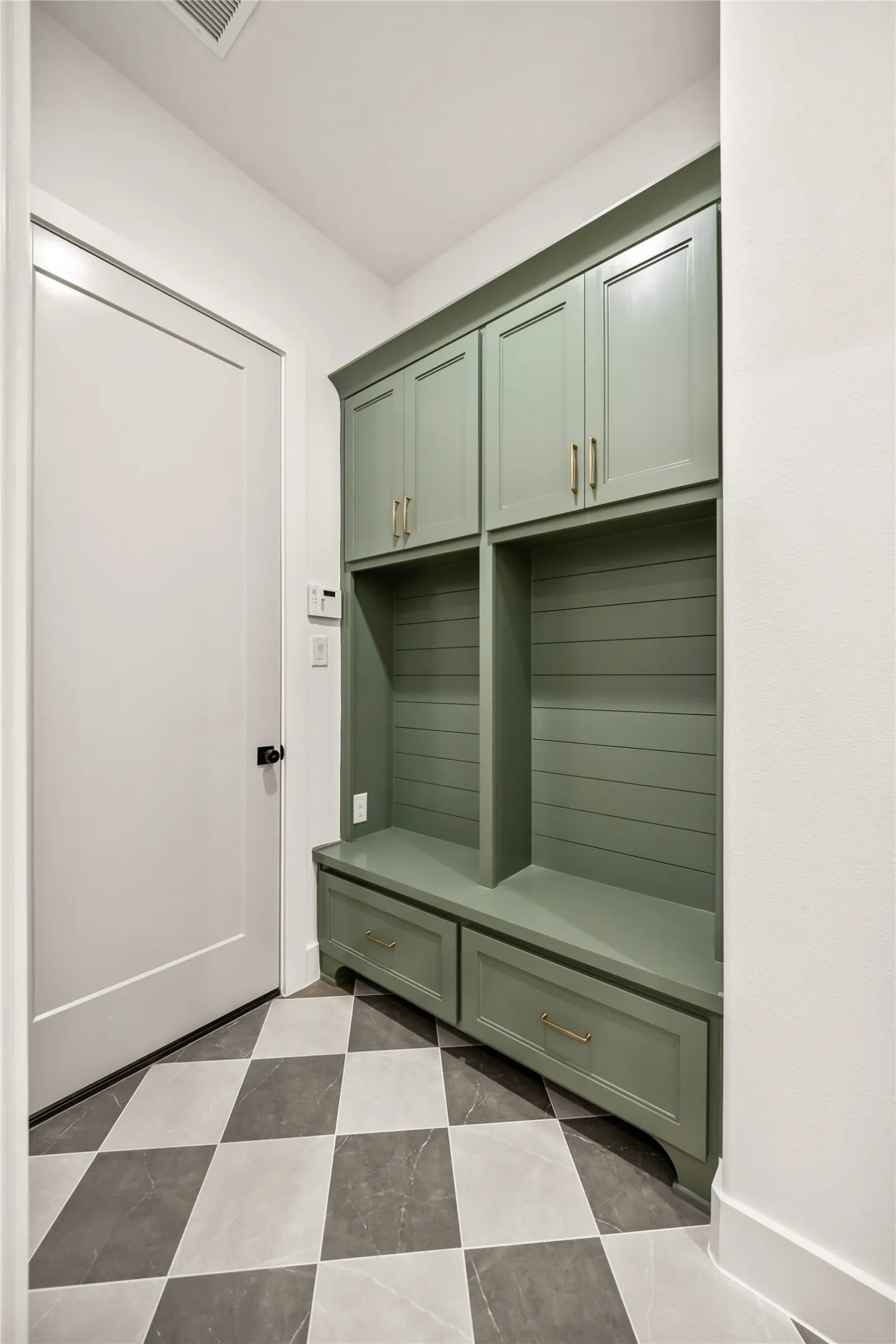 Built-in storage system with painted cabinetry and brass hardware