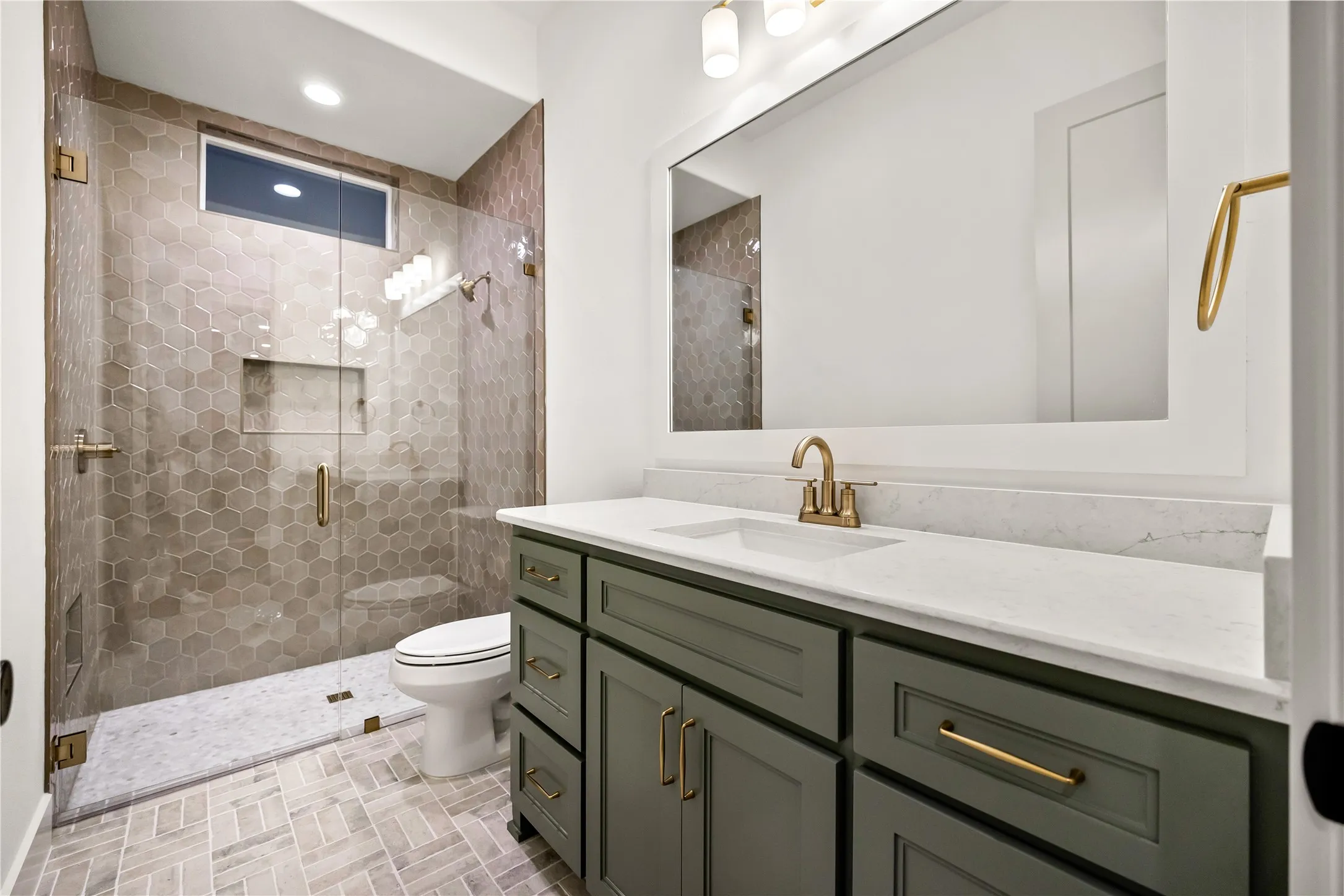 Custom vanity with a white countertop and gold-finish fixtures