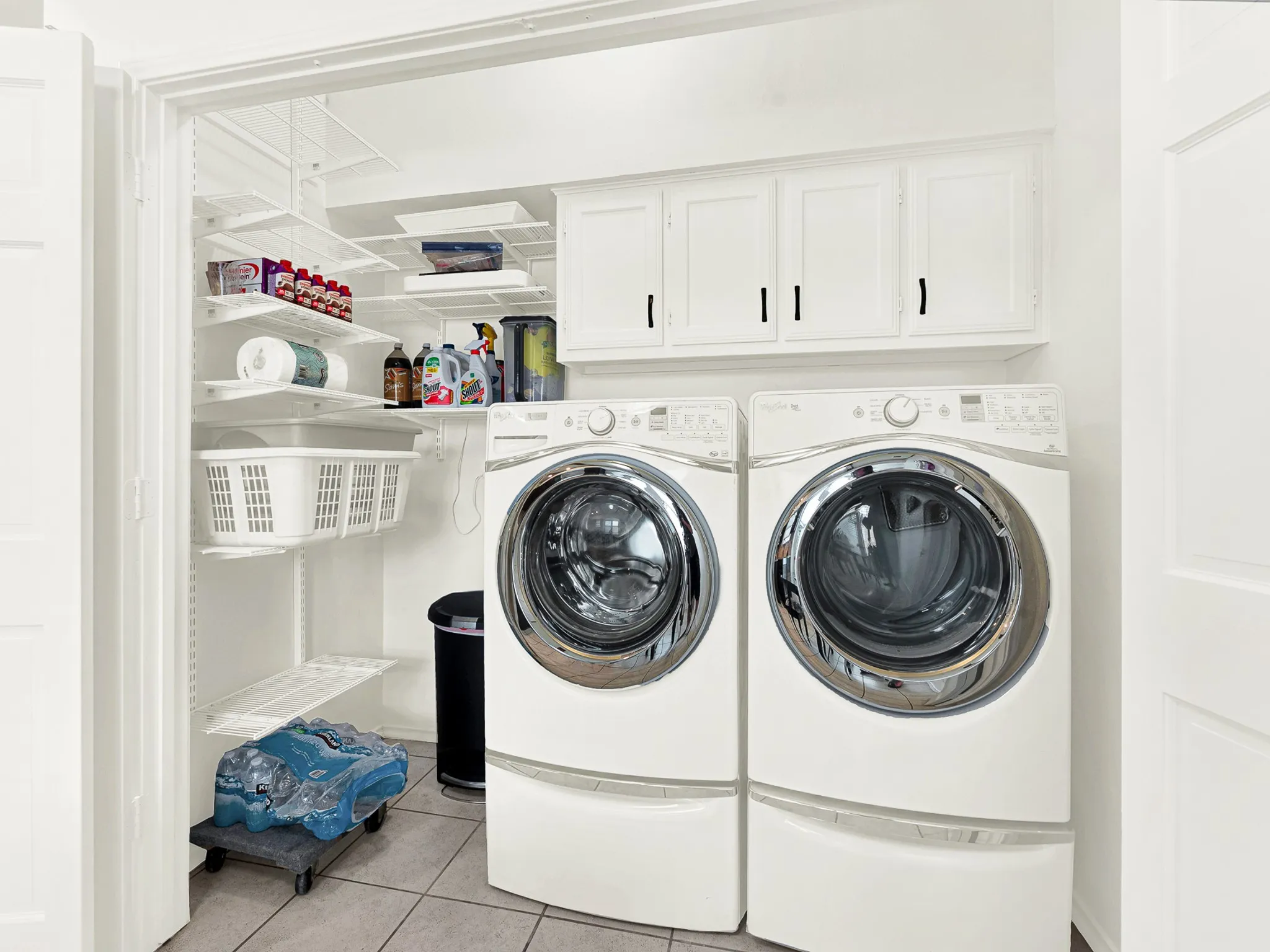 The laundry area provides full size washer dryer space, and extra storage shelving, cabinets above the W/D for storing your supplies so they are out of reach for safey.