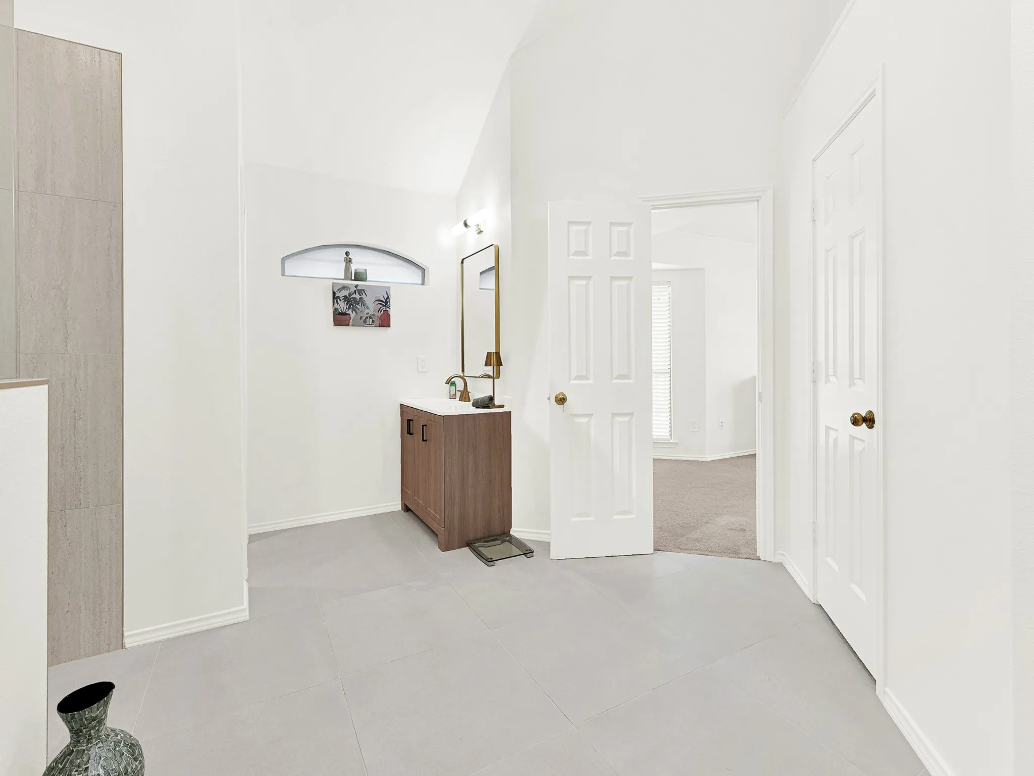 Soring ceiling in this spa like bathroom make getting ready each day enjoyable.