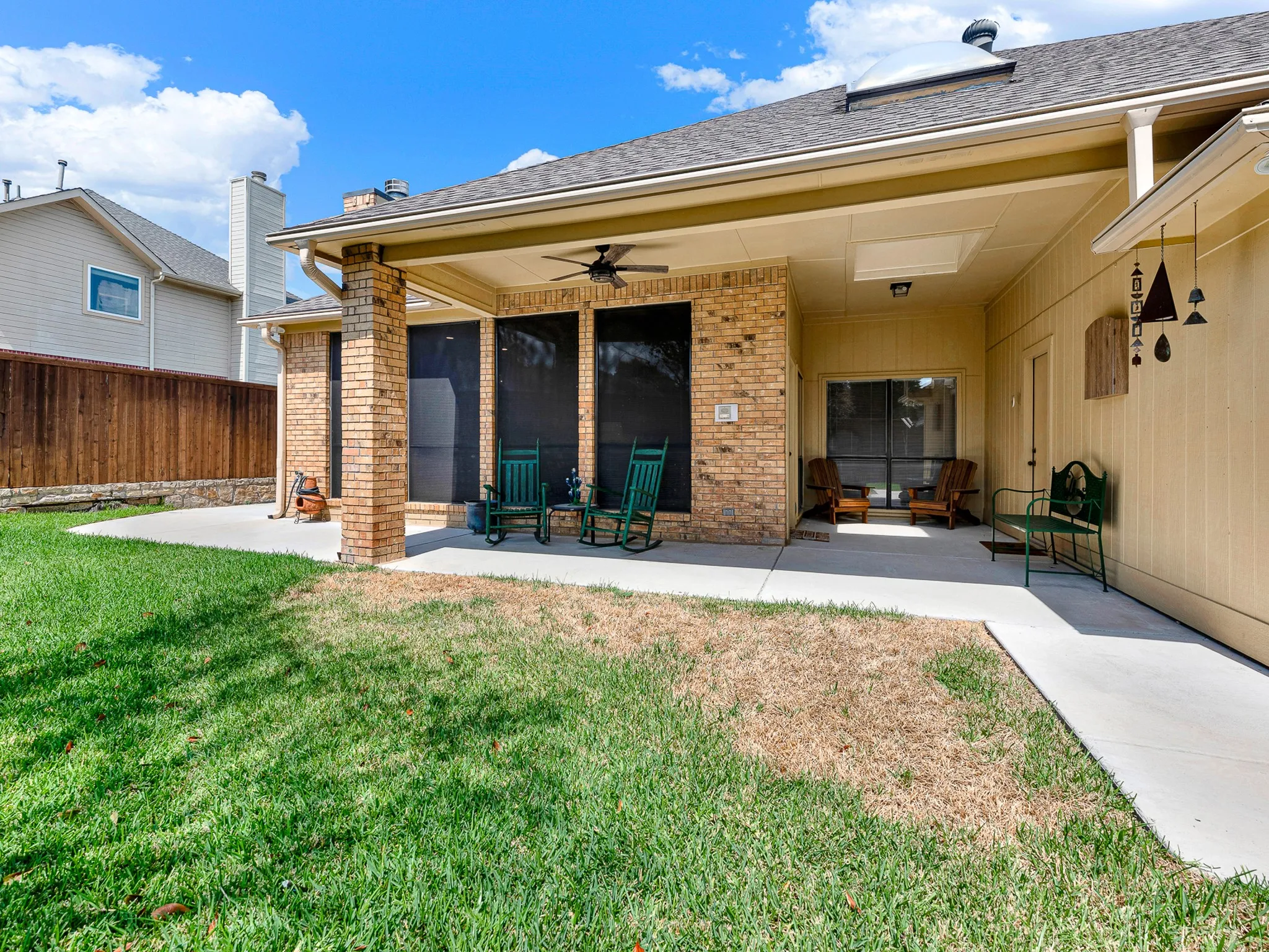 Over sized patio that wraps around the side of house.