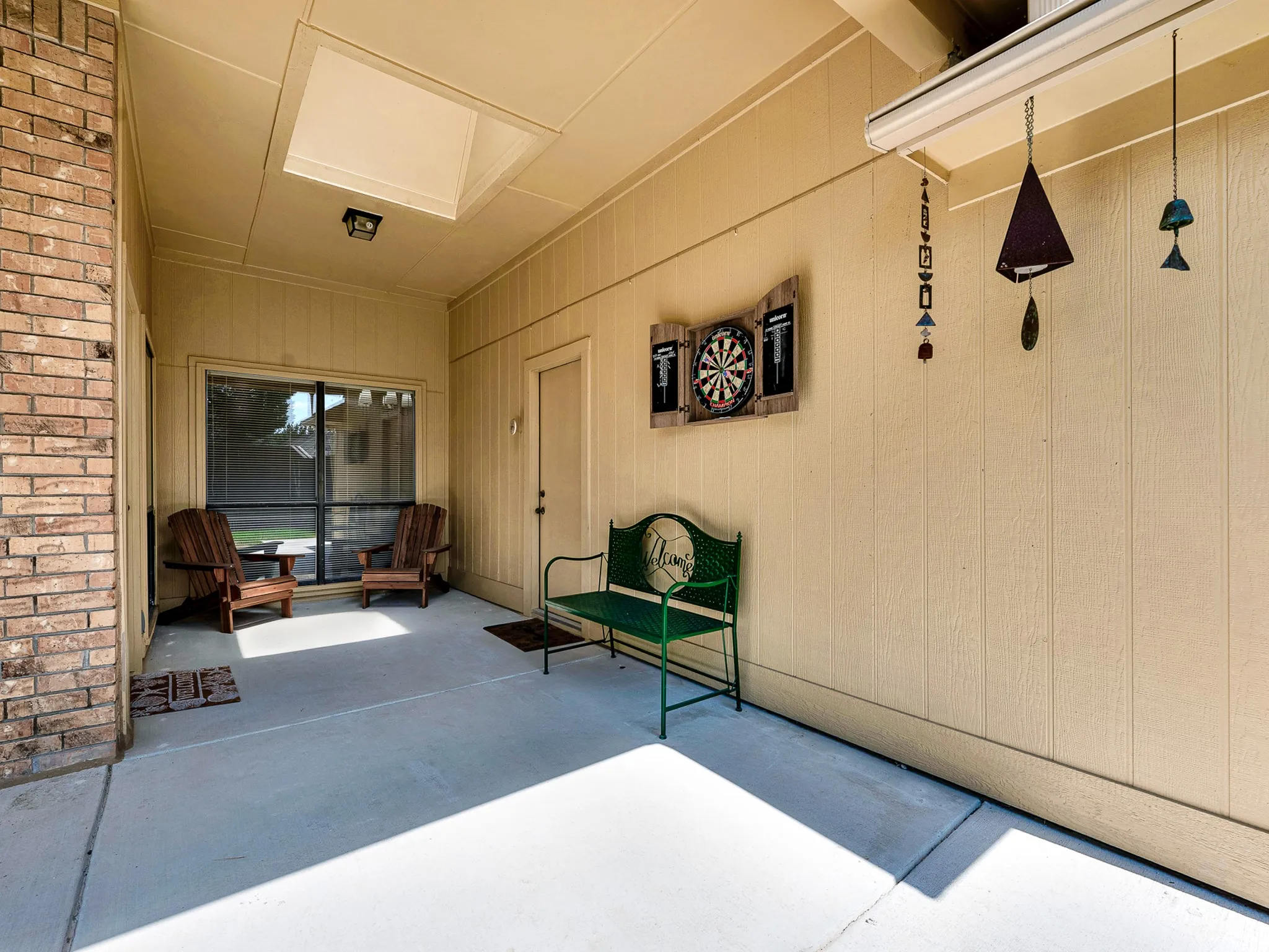 Welcome to you back patio where you can sit and enjoy the outdoors in the shade and entertain family and friends. quick access to the garage as well.