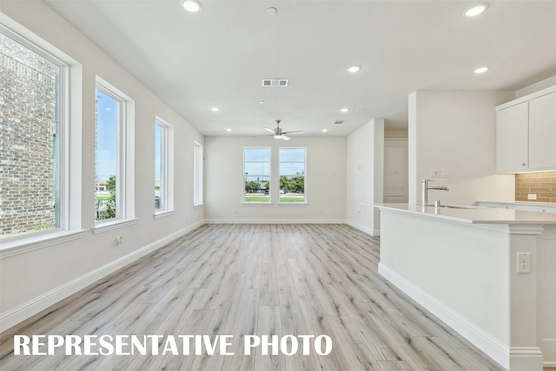 Light, bright and airy, this open concept kitchen-dining-family room is everything you have been searching for in a lock and leave lifestyle home!  REPRESENTATIVE PHOTO