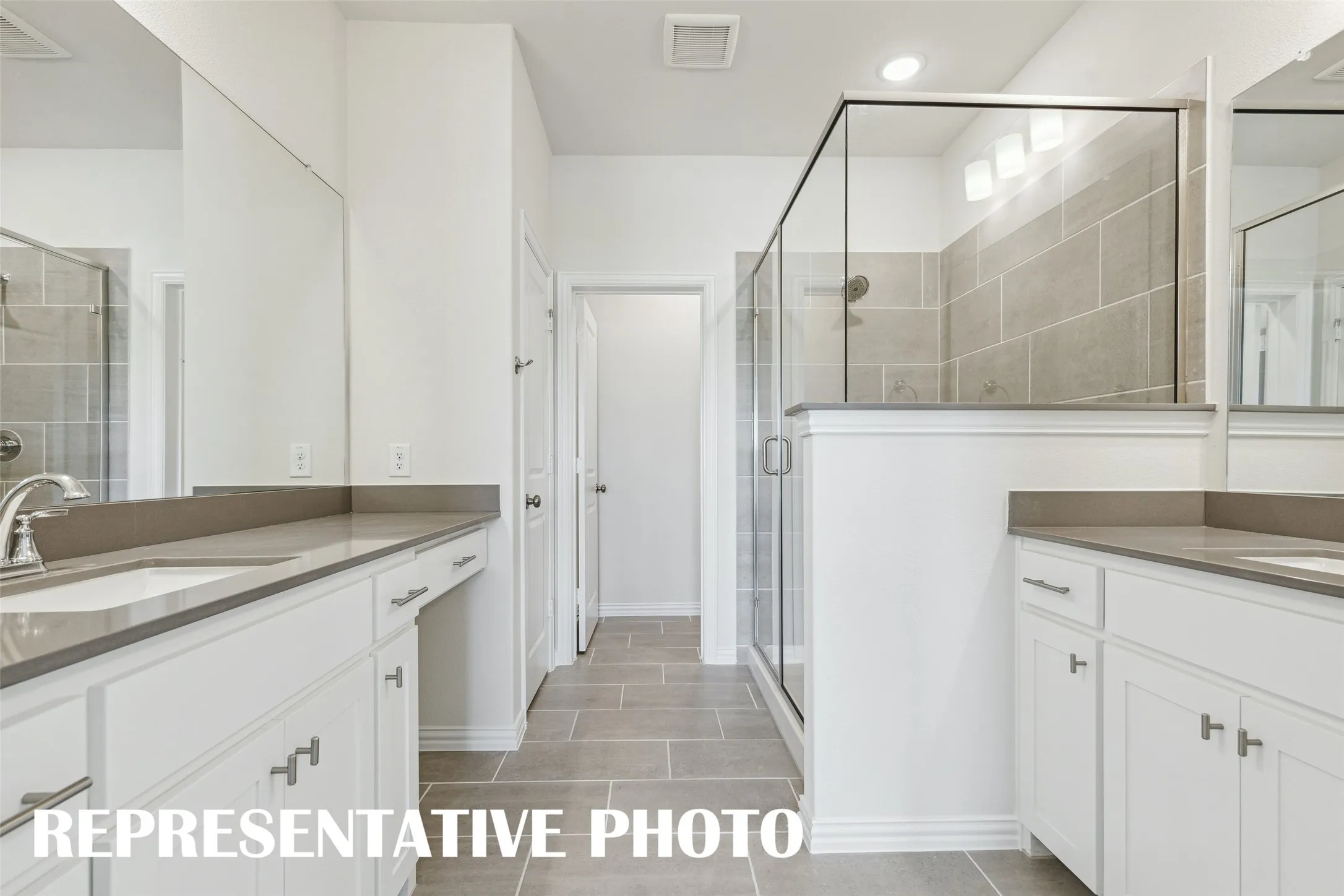 This spa like owner's bath with spacious walk in shower is the perfect place to start or end your day!  REPRESENTATIVE PHOTO