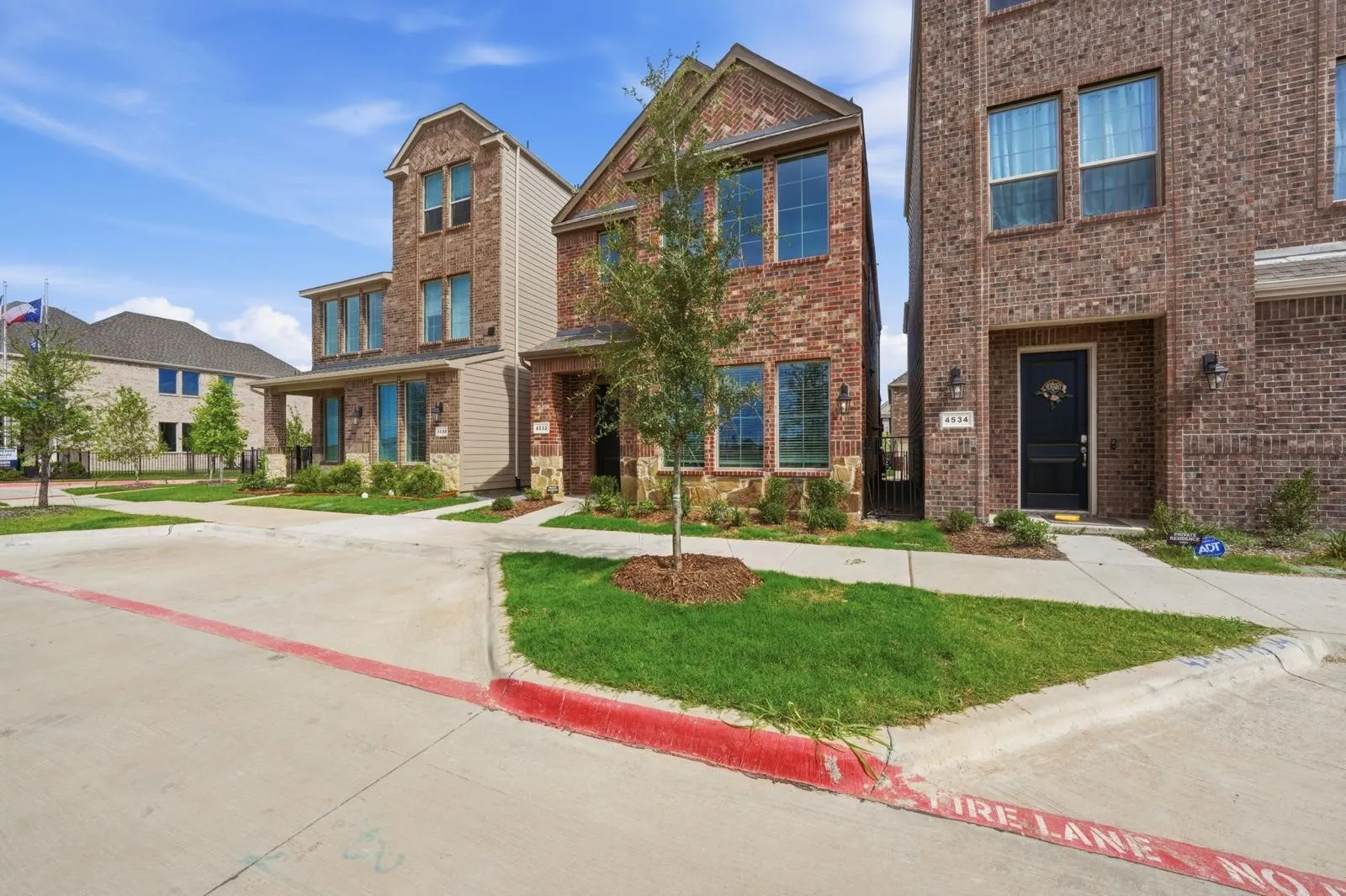 Brick exterior with contrasting siding accents, multiple windows, and a covered entry