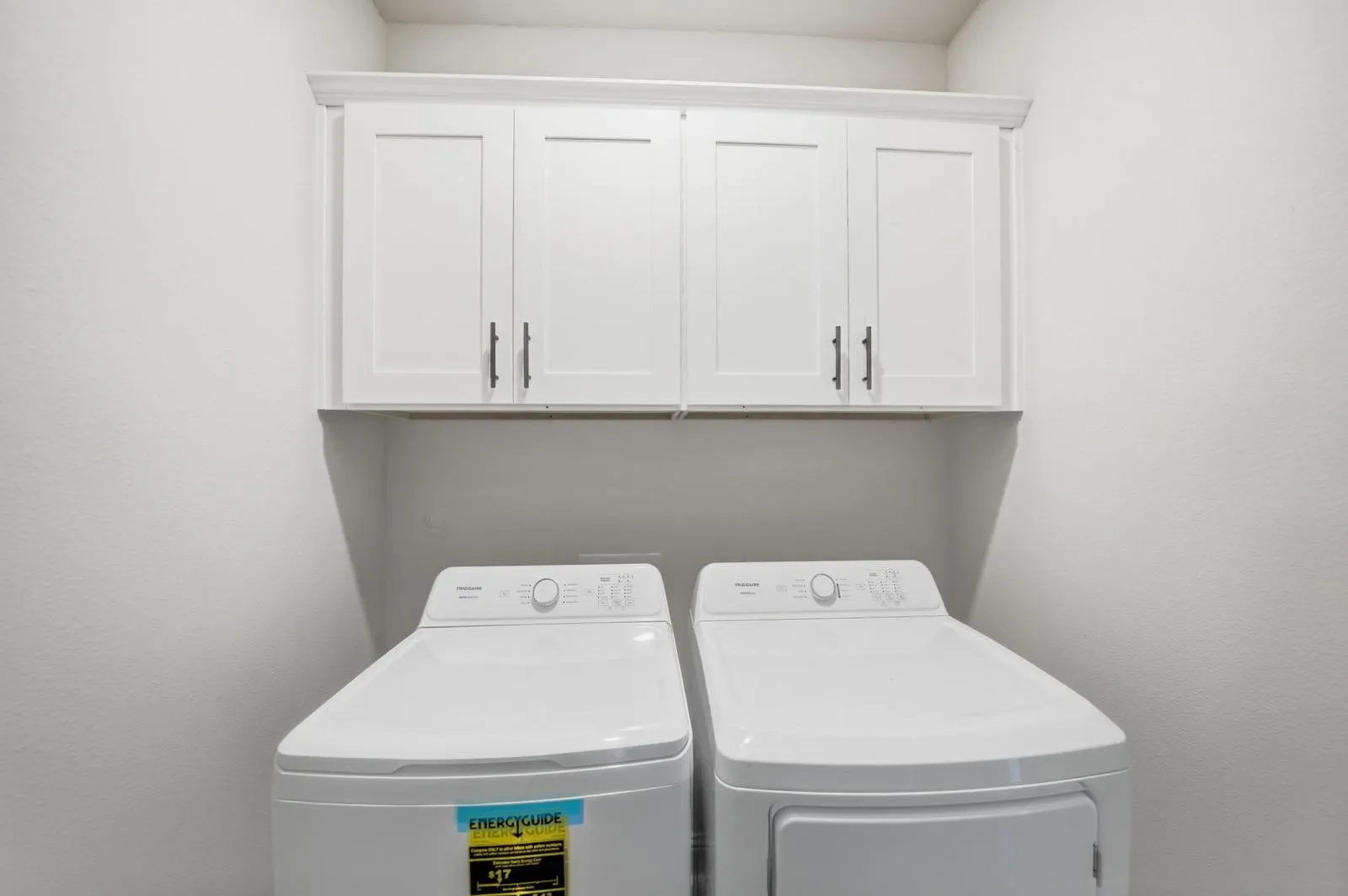 White shaker-style cabinetry with dark hardware