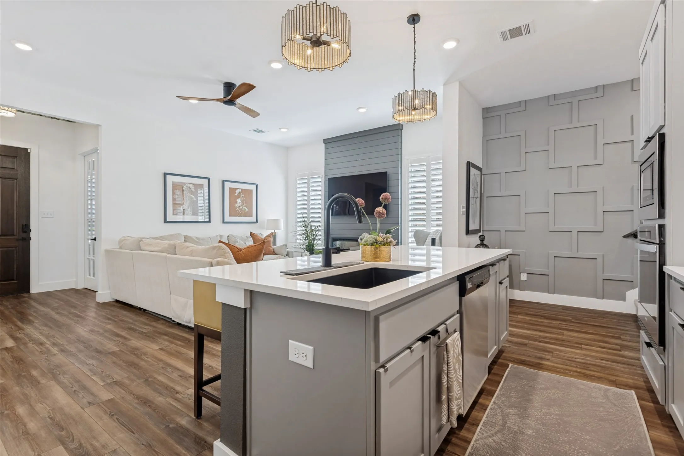 Gourmet kitchen island with an undermount sink and stainless steel appliances