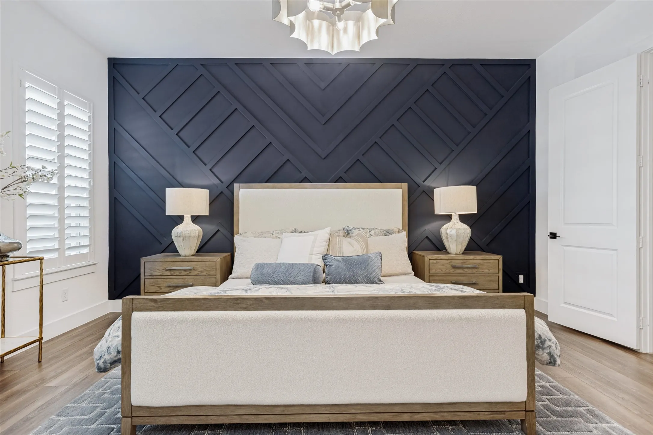 Custom board and batten accent wall with elevated lighting.