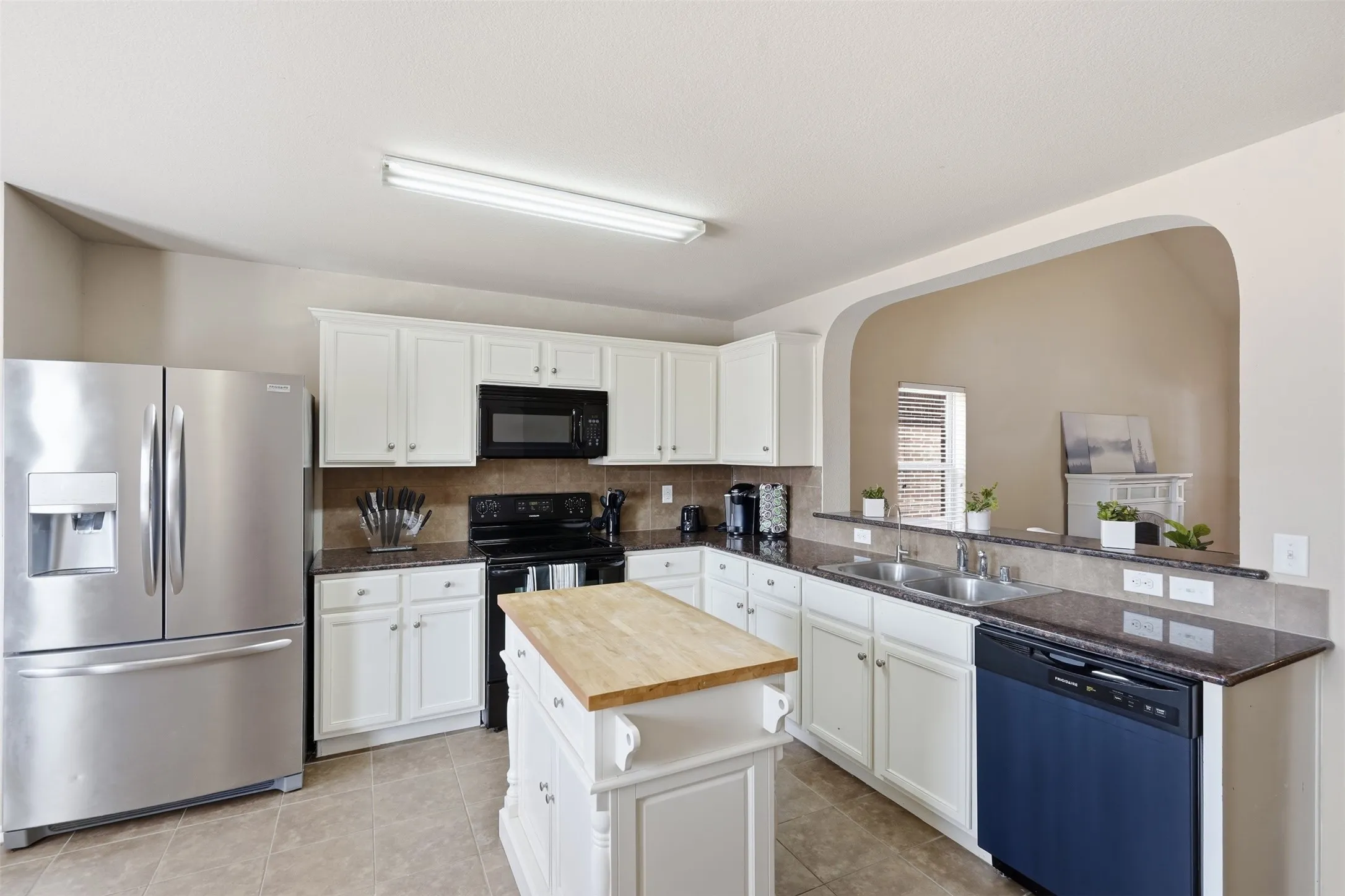 A bright, functional kitchen anchors the main living area of this move-in-ready 4-bedroom Waxahachie home