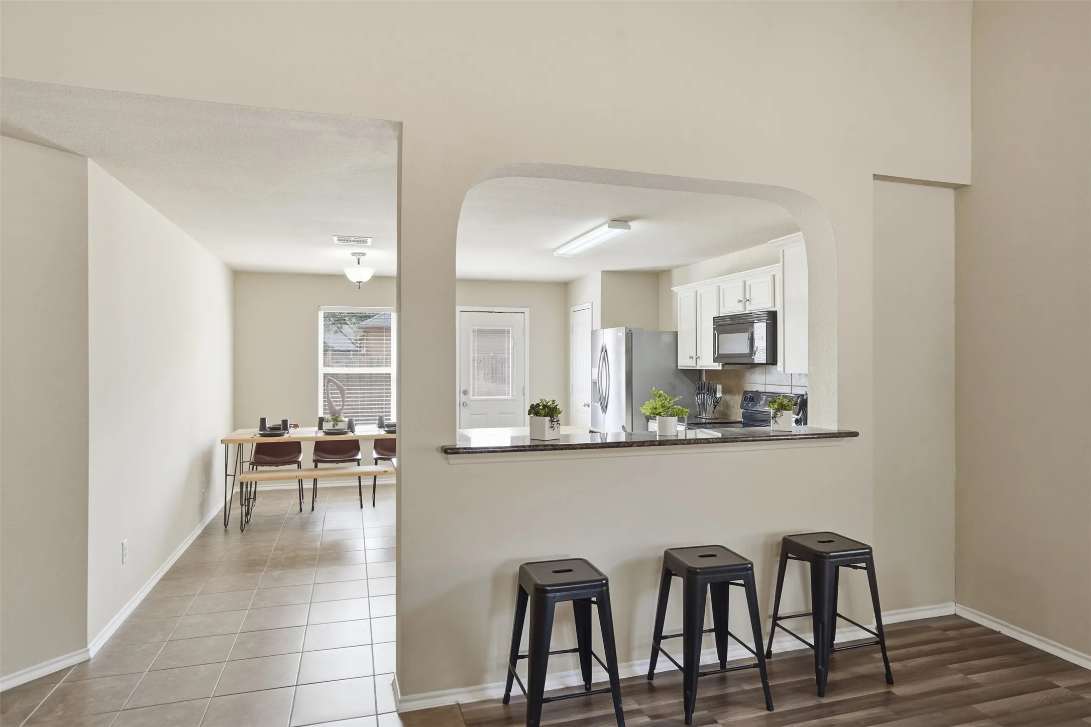 The updated kitchen offers generous cabinet storage, ample counter space, and an efficient layout for everyday meals and entertaining