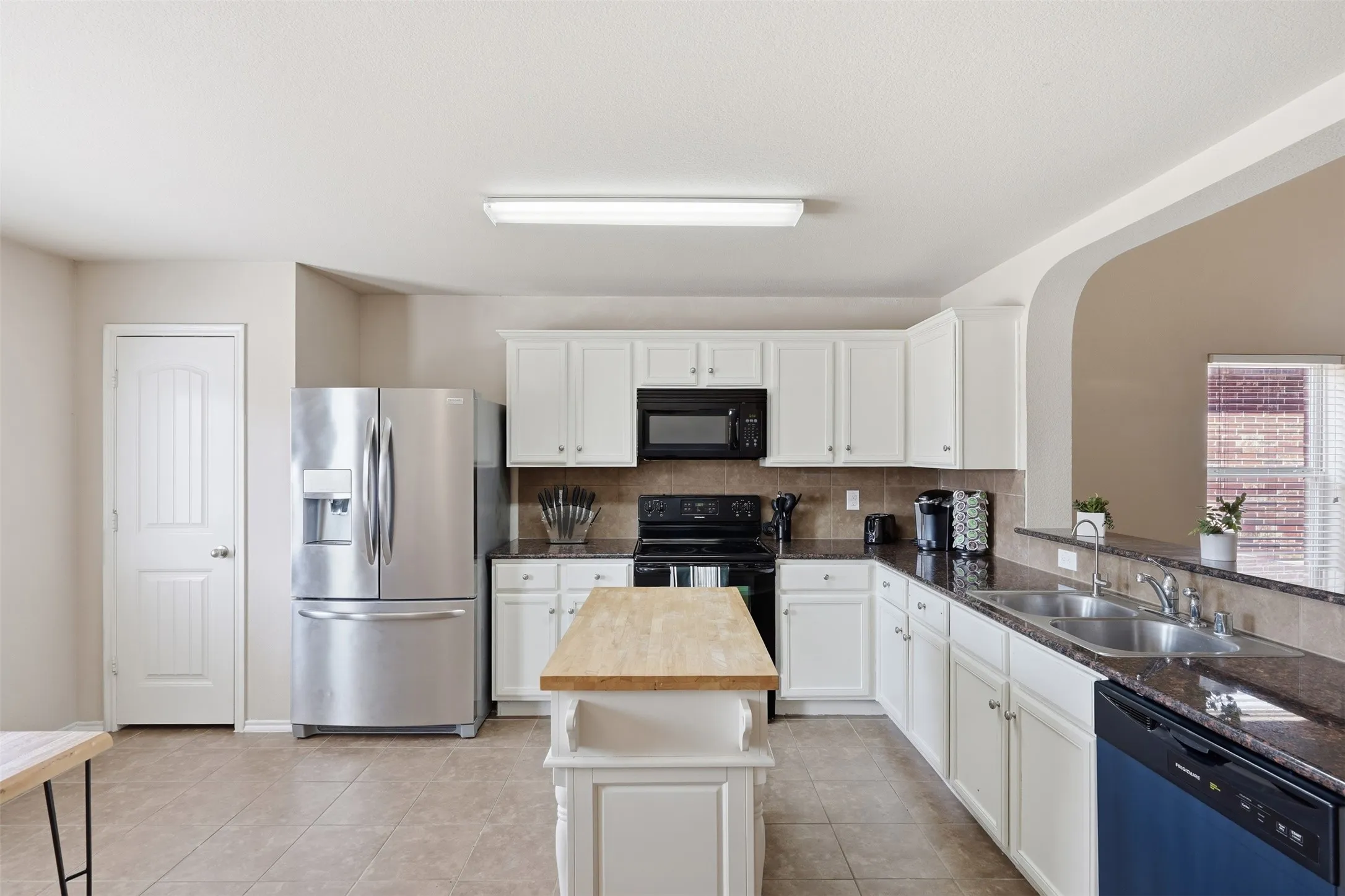 A bright, functional kitchen anchors the main living area of this move-in-ready 4-bedroom Waxahachie home