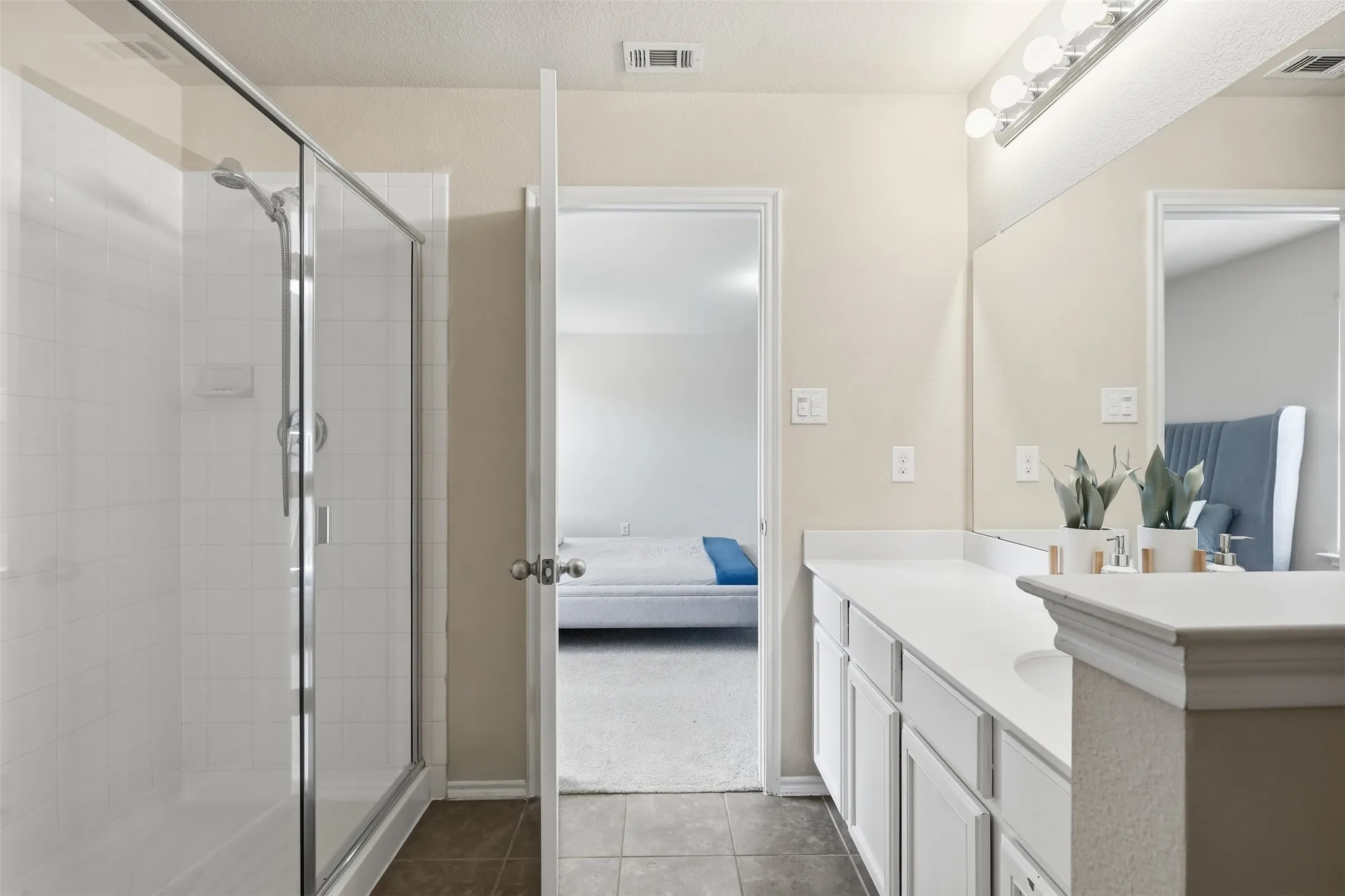 The primary bathroom provides a functional space for preparing for the day or unwinding at home
