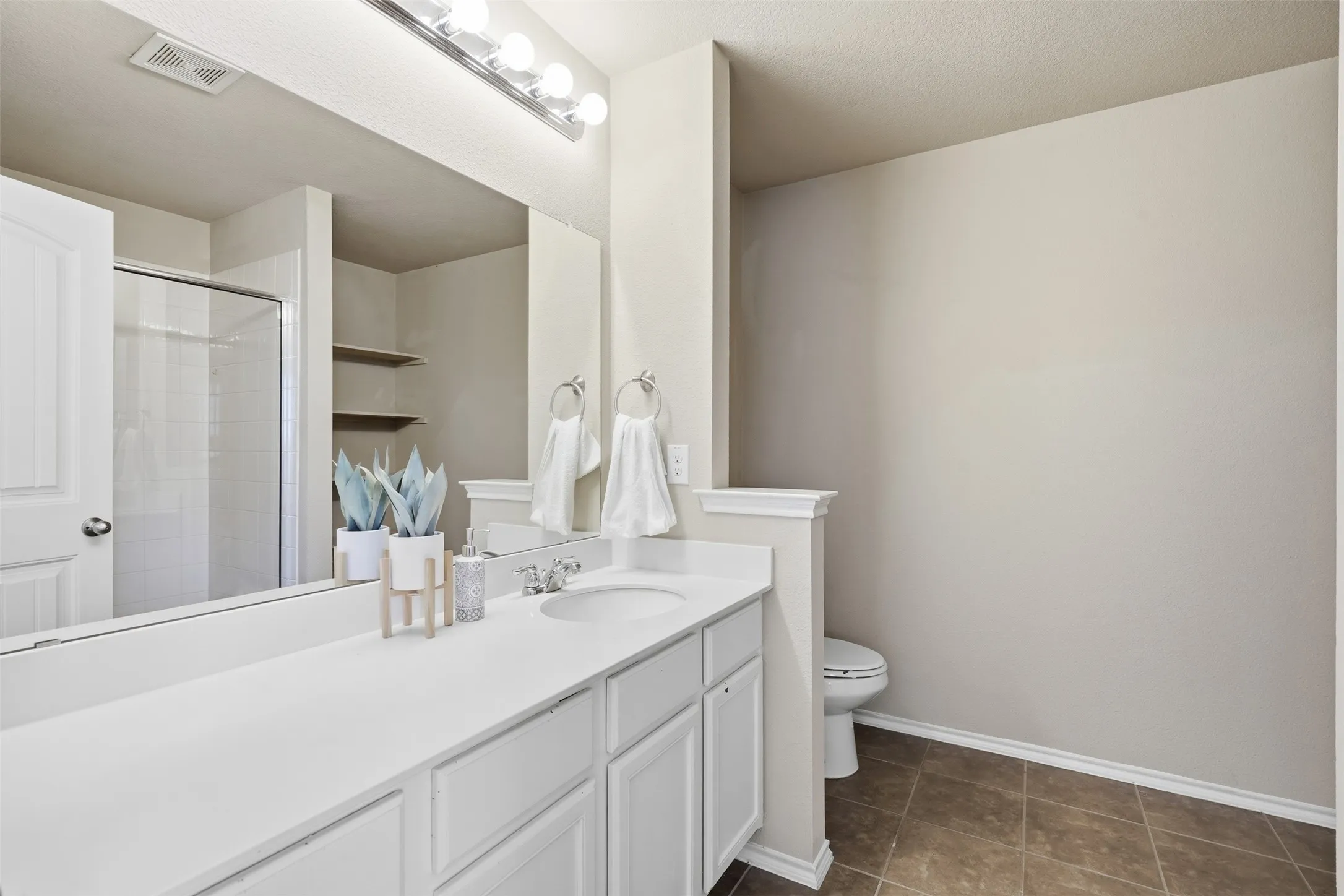 This spacious upstairs bedroom adds versatility for a growing household, visiting guests, or work-from-home needs