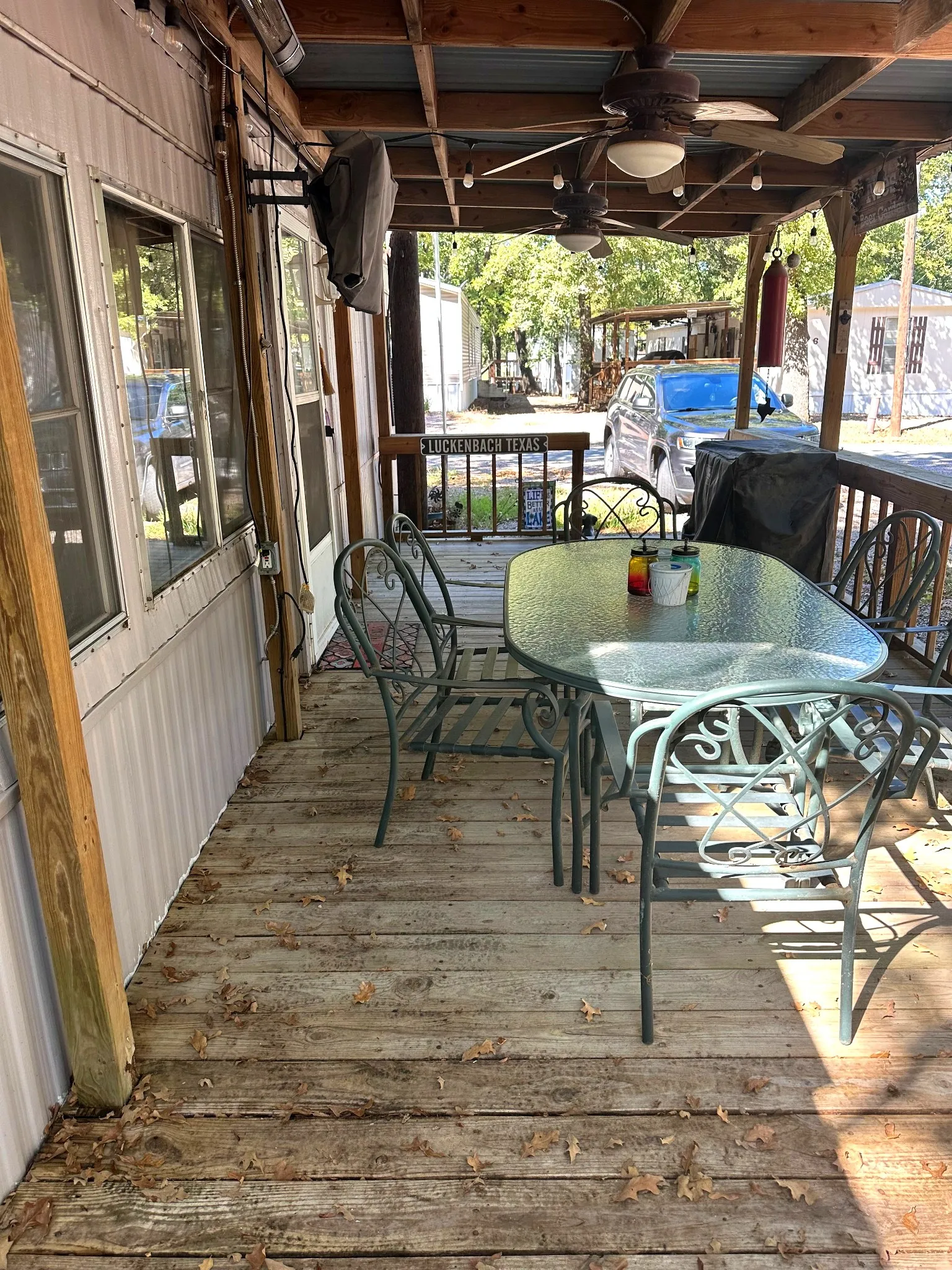 Covered porch featuring wood flooring