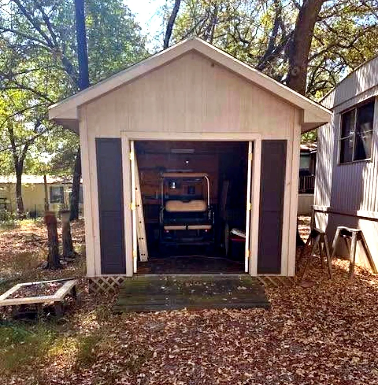 Gable roof shed featuring a single bay entry with double doors and decorative shutters