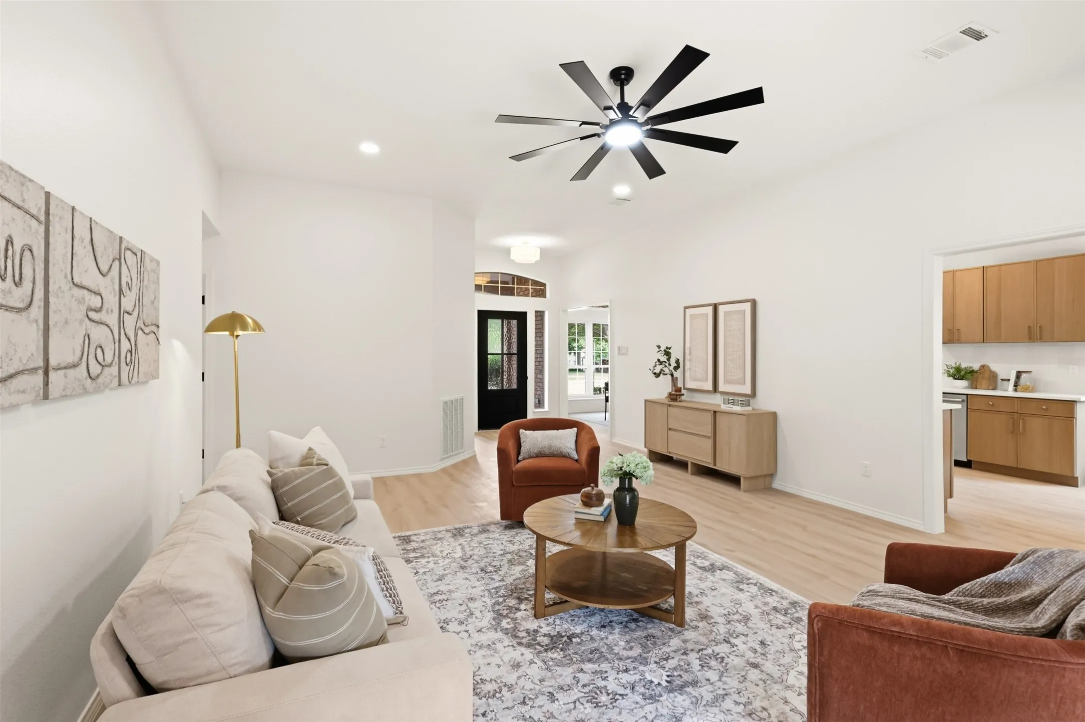 Vaulted ceilings, wood-finish flooring, recessed lighting, and a modern ceiling fan