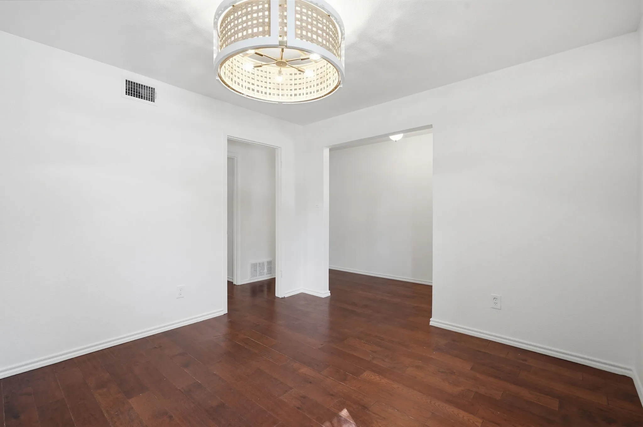 Recessed lighting, wood-finish flooring, and white walls