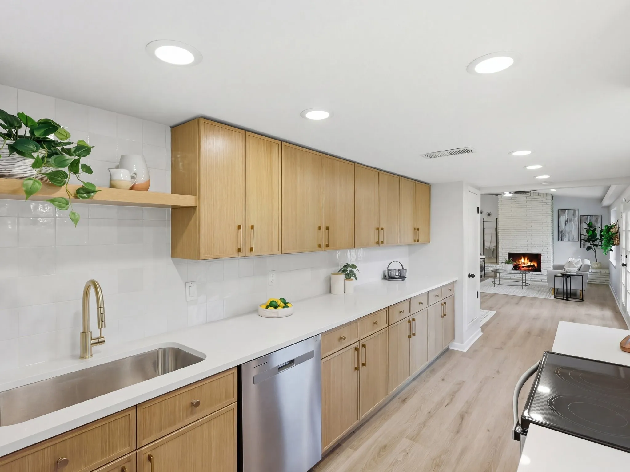 Contemporary kitchen featuring wood-finish cabinetry, stainless steel sink, and light-tone countertops