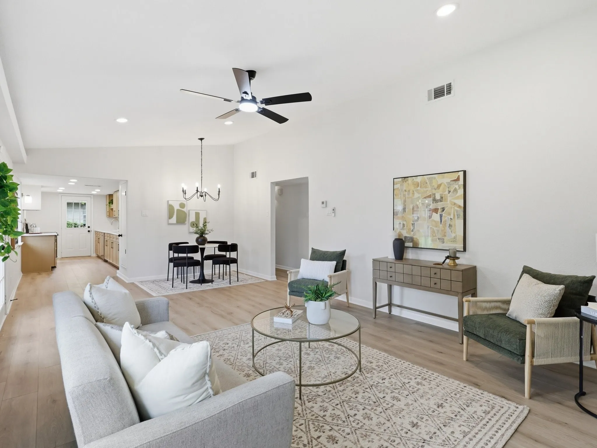 Vaulted ceiling, recessed lighting, wood-finish flooring, ceiling fan, and an open-concept layout