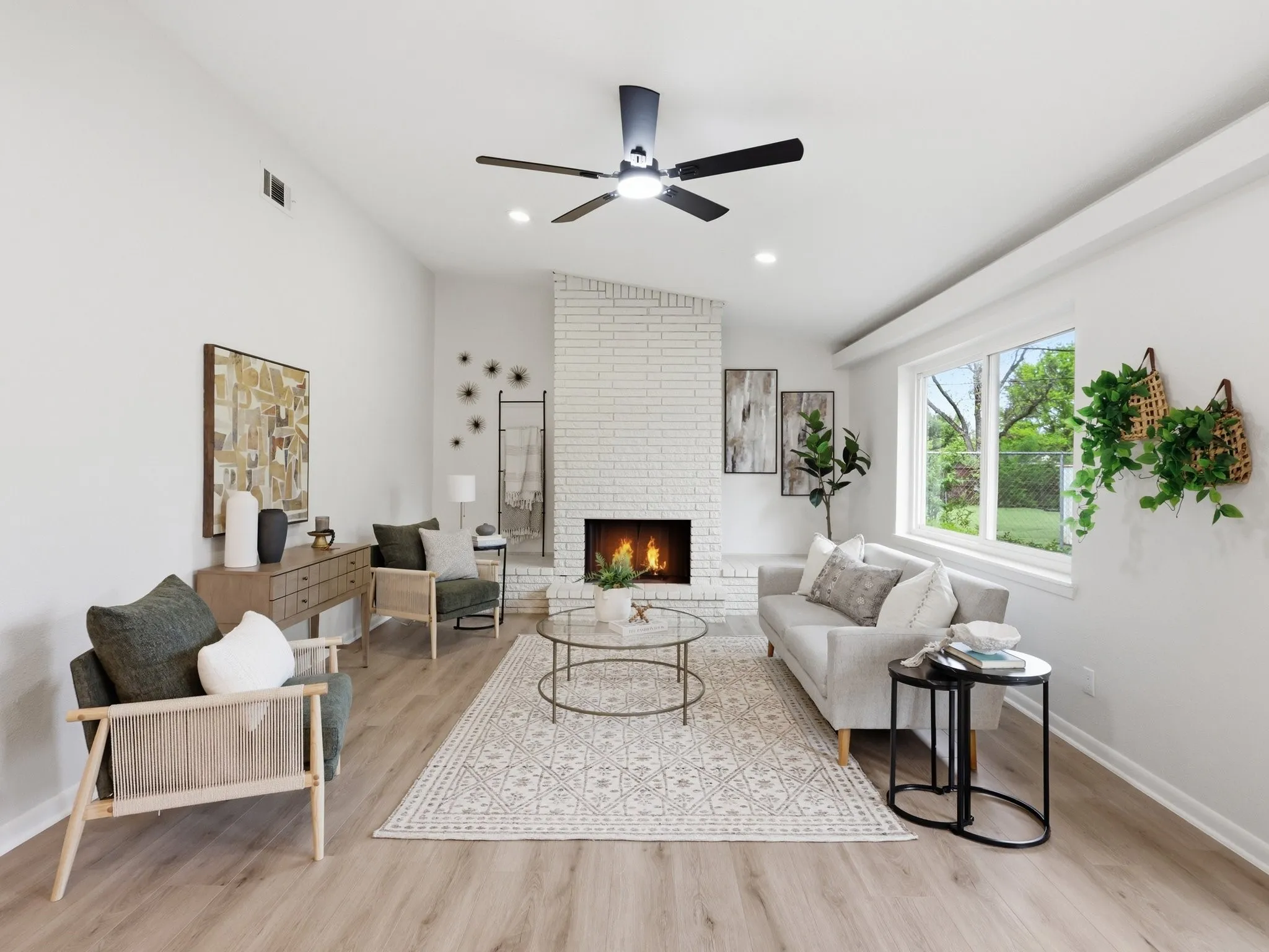 Vaulted ceiling with a ceiling fan, white brick fireplace, recessed lighting, wood-finish flooring, and large window