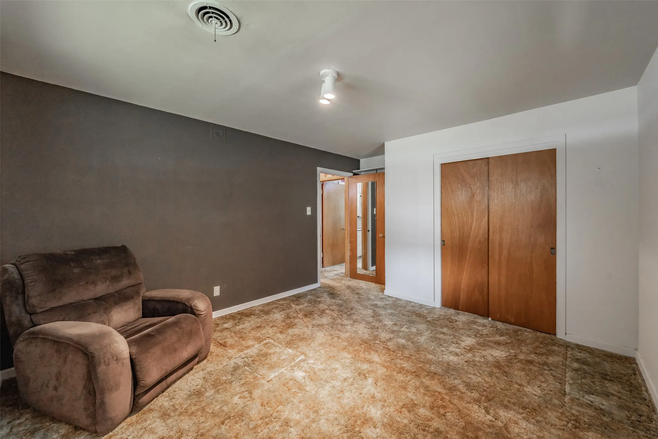 Neutral wall tones with a wood-finish closet door