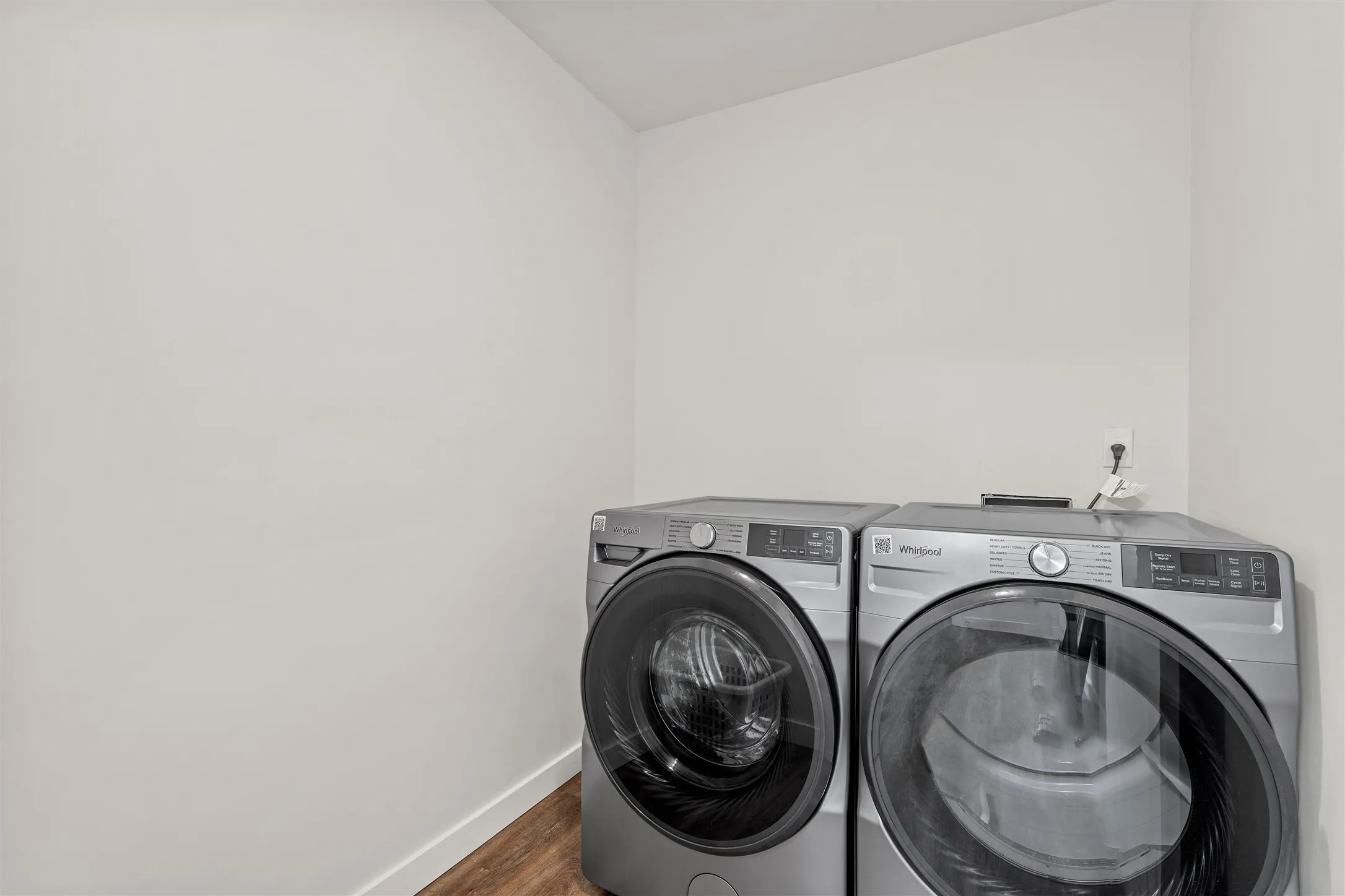 Utility area with wood-finish flooring