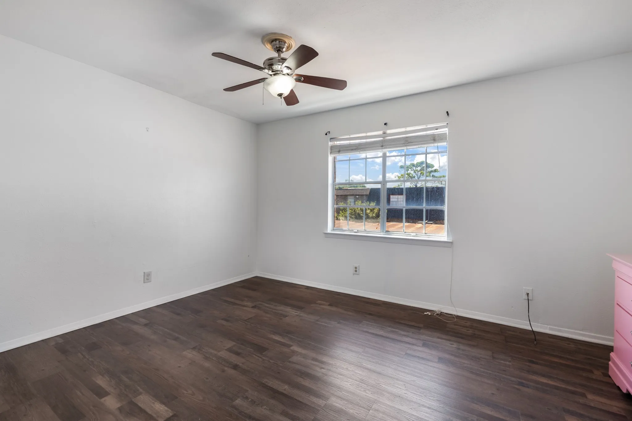 Wood-finish flooring, ceiling fan, and a window with blinds