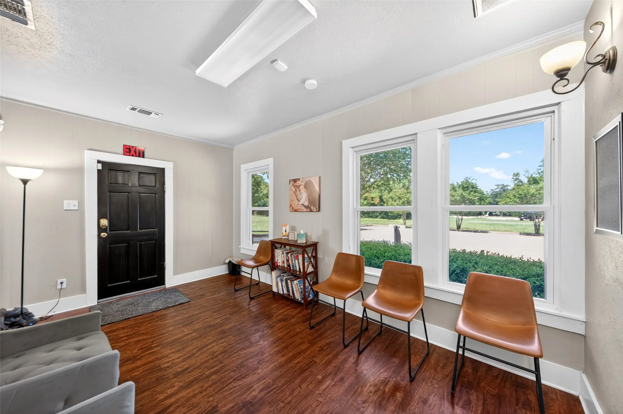 Wood-finish flooring with white trim and neutral wall paint