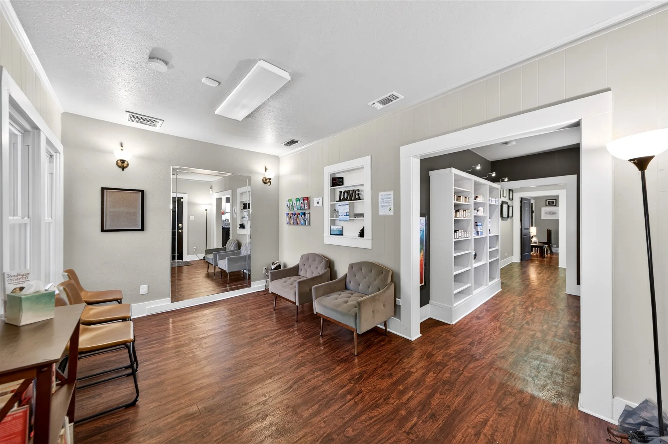 Wood-finish flooring, recessed lighting, and a full-height wall mirror