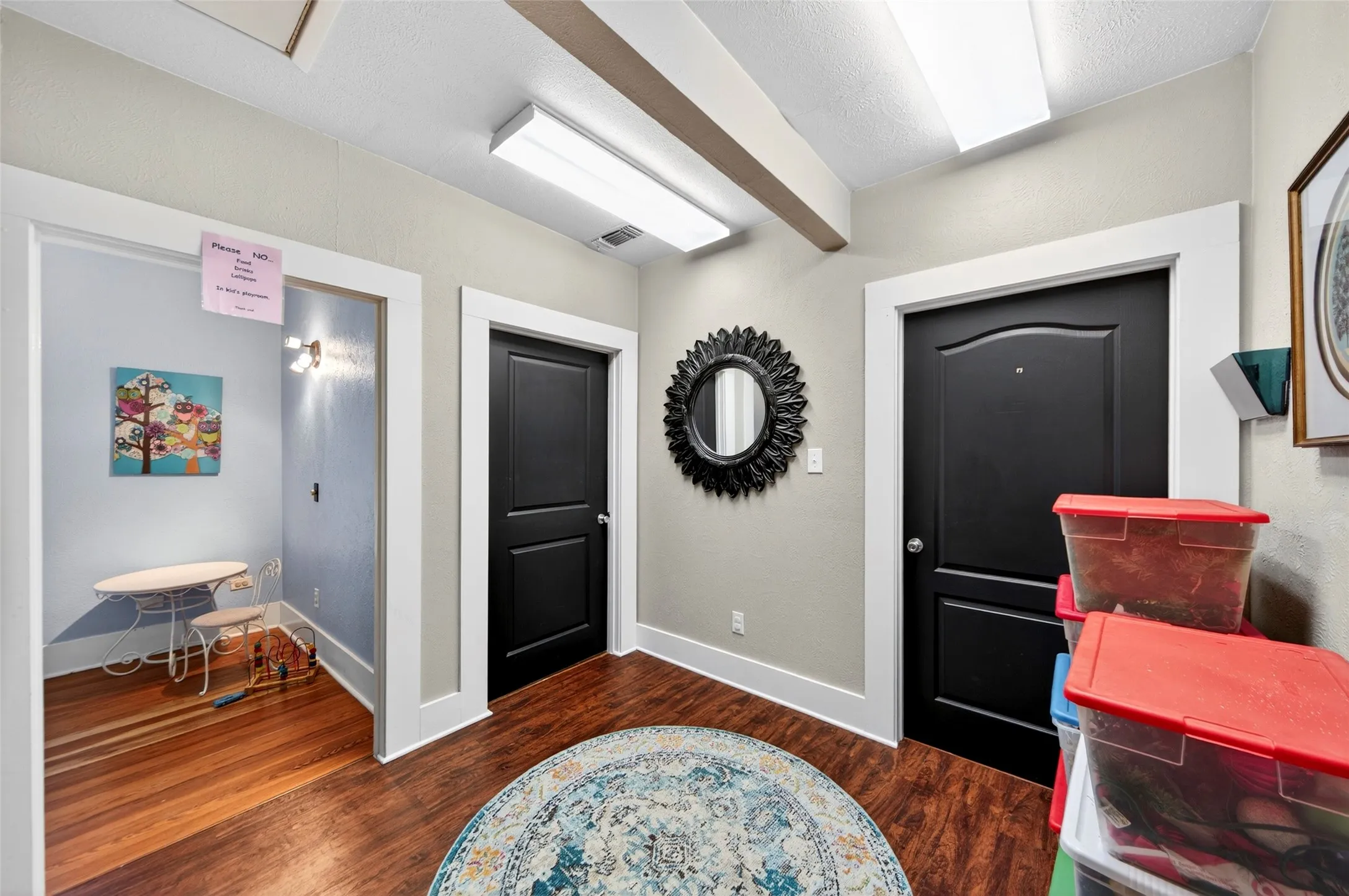 Hallway featuring wood-finish flooring, white trim, and recessed lighting