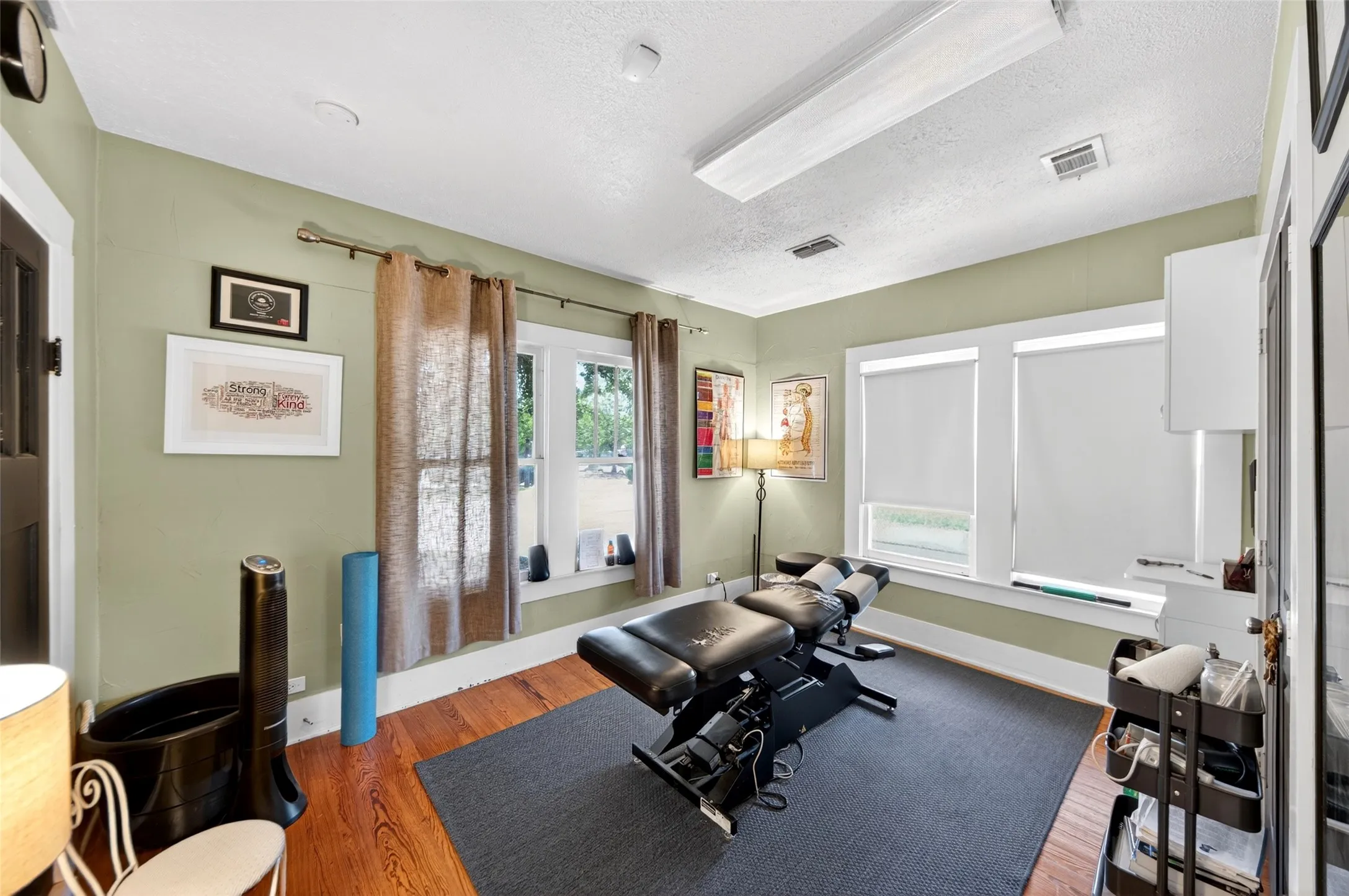 Hardwood flooring, multiple windows, overhead lighting, crown molding, built-in wall cabinet