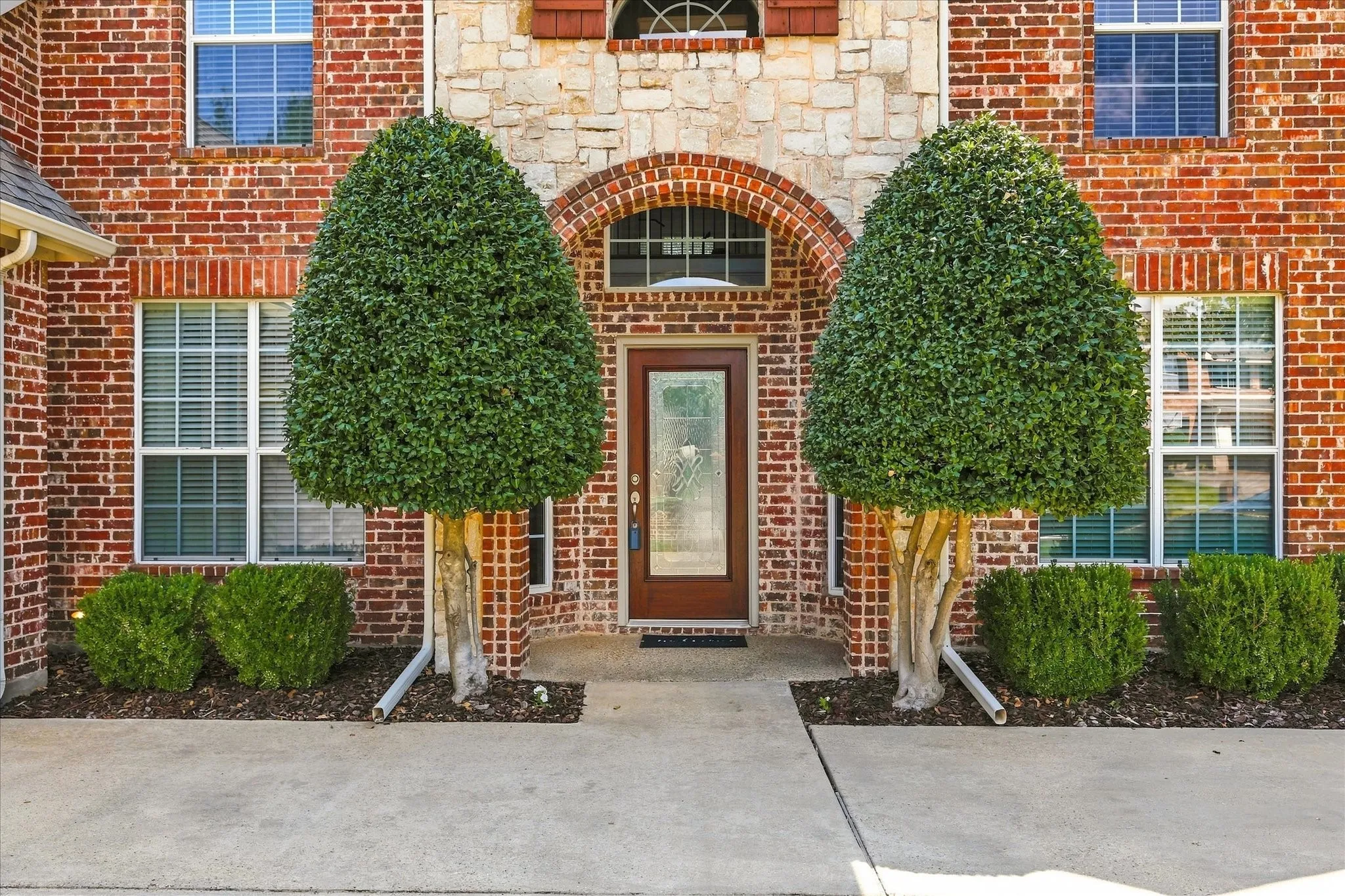 Brick and stone facade with arched entry