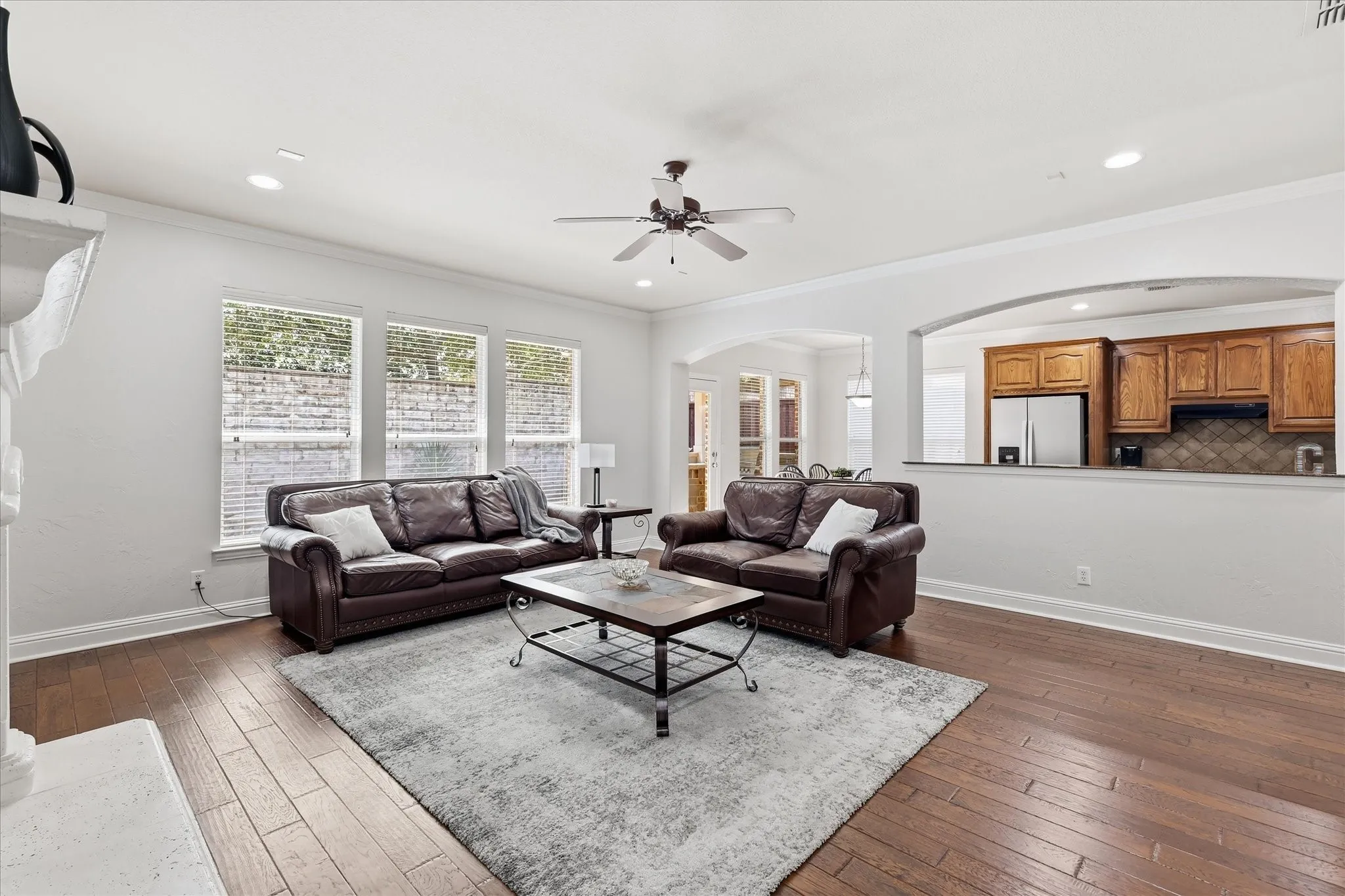 Hardwood-finish flooring, recessed lighting, and a ceiling fan