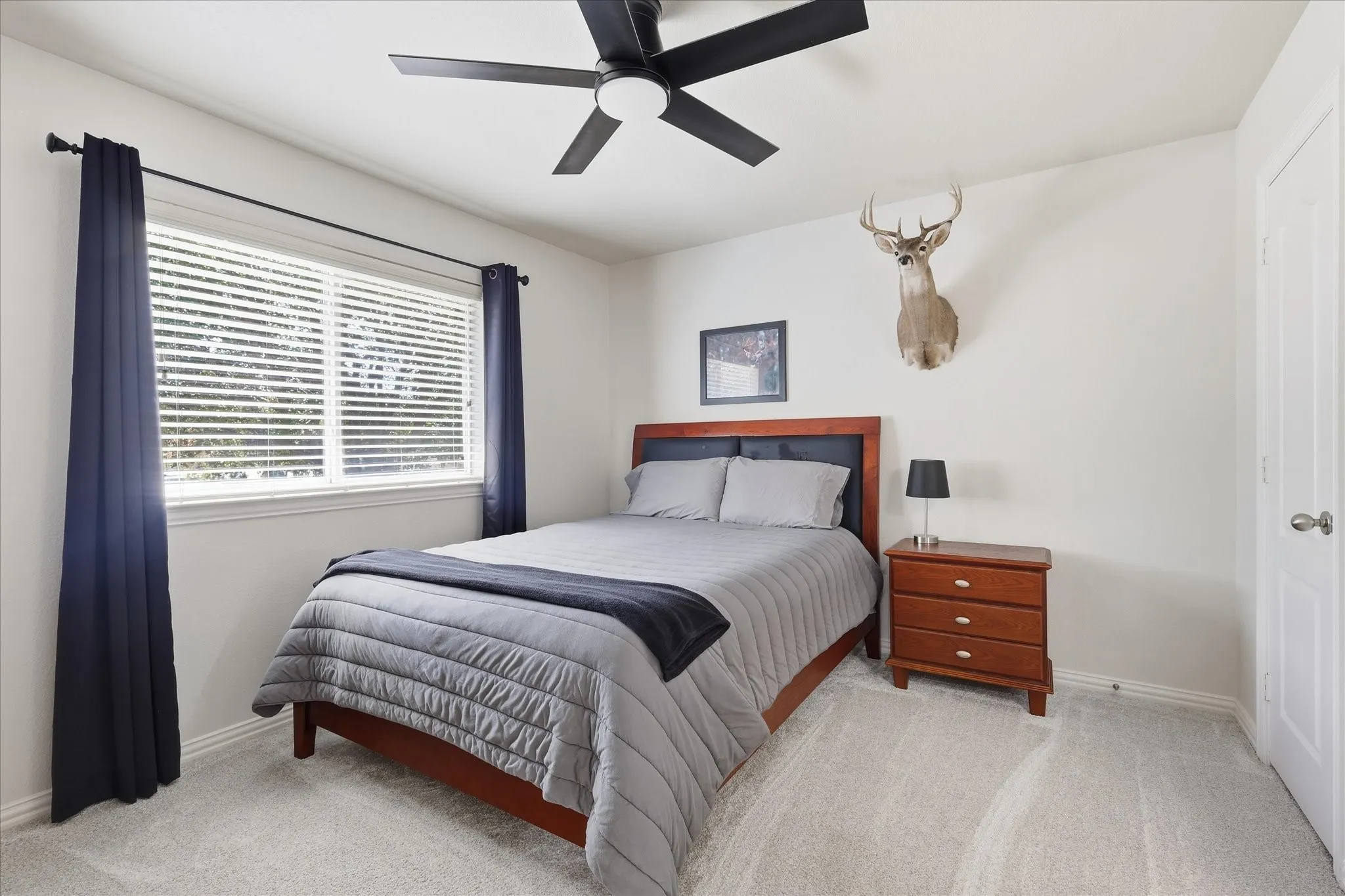 Recessed lighting, ceiling fan with integrated light, light gray carpeting, window with blinds, and white door