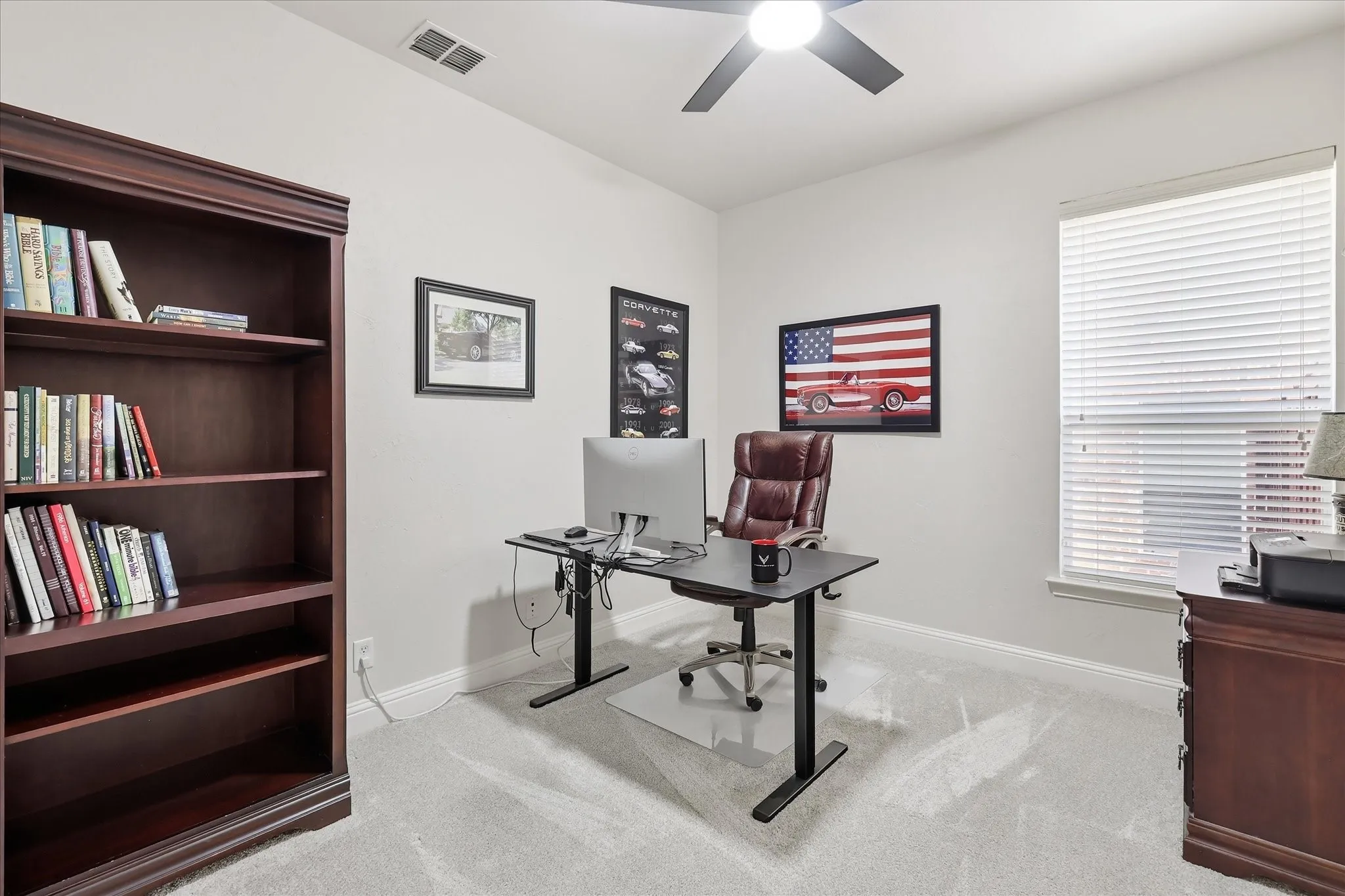Room featuring light-colored walls, window with blinds, and ceiling fan with integrated lighting