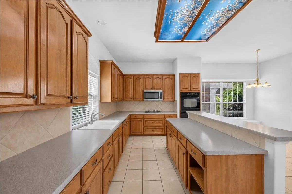 Extensive wood cabinetry, durable countertops, and tile flooring
